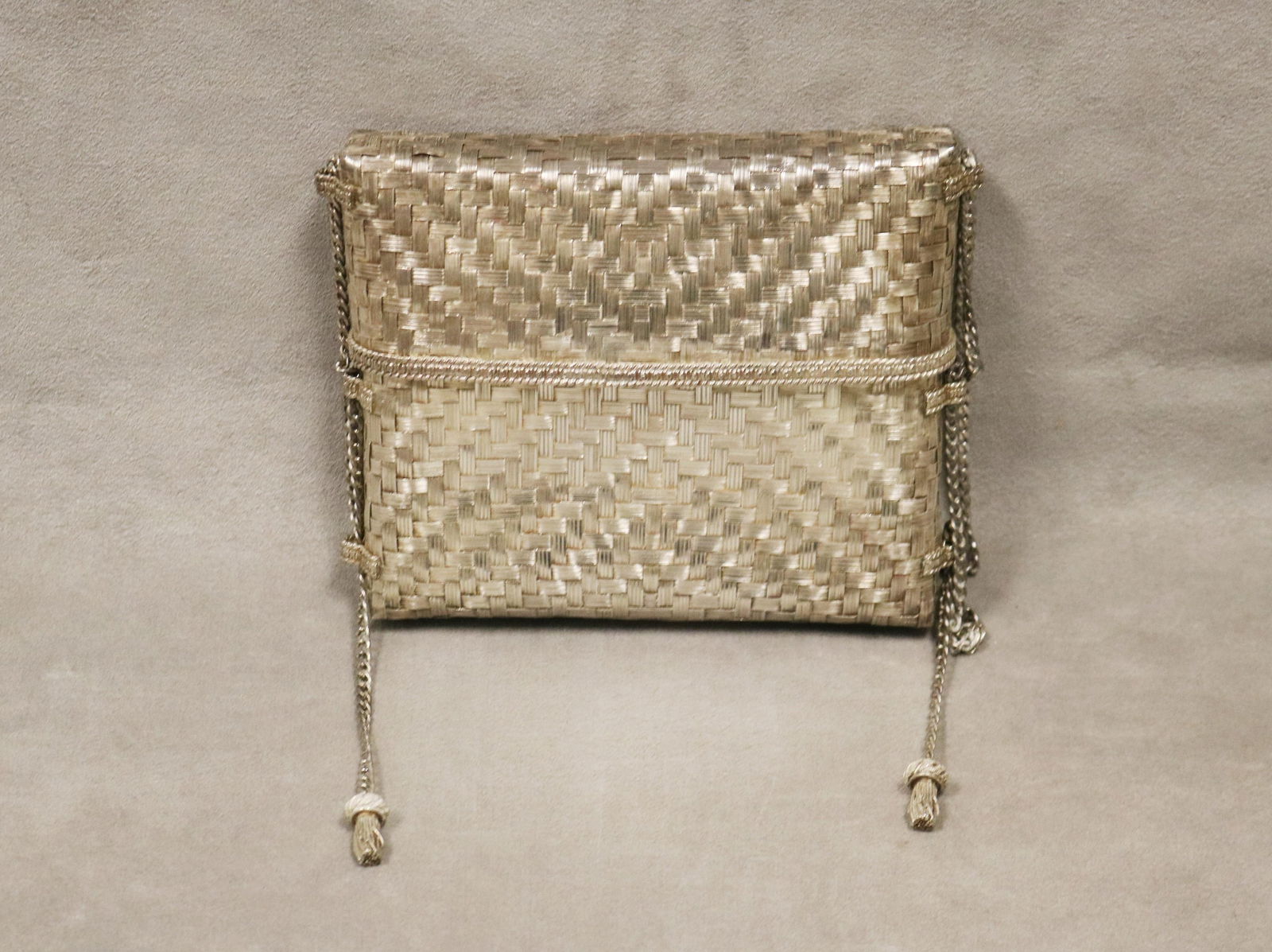 MEXICAN STERLING SILVER WOVEN EVENING BAG OR MINAUDIERE BY TANE IN THE STYLE OF ELSE PERETTI Marked: MEXICAN STERLING SILVER WOVEN EVENING BAG OR MINAUDIERE BY TANE IN THE STYLE OF ELSE PERETTI Marked "TANE", "MEX" and ".925" In two parts. With chain with cast metal tassels. Wt.15 troy oz. App. 5 3/4