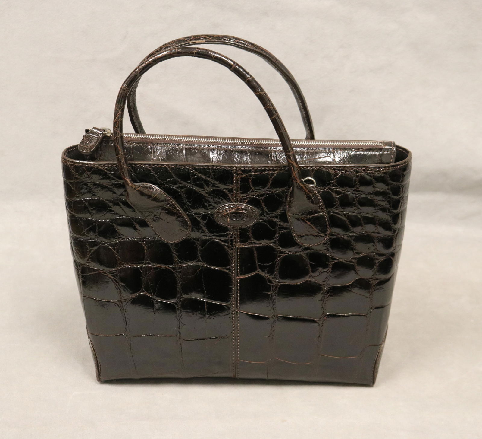 TOD'S BROWN ALLIGATOR DOUBLE-HANDLE D-BAG Made in Italy - 11 1/2 in. x 9 in. x 4 in..: TOD'S BROWN ALLIGATOR DOUBLE-HANDLE D-BAG Made in Italy Double rolled alligator handles; zip closure; removable shoulder strap with silver-tone hardware; inner zip pocketThe D-bag was named after Prin