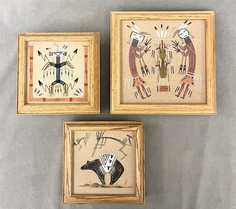 THREE NAVAJO (DINE) NATIVE AMERICAN SAND PAINTINGS.: THREE NAVAJO (DINE) NATIVE AMERICAN SAND PAINTINGS. Each is the top to a wooden container. Two signed (possibly by Veronica Begay) depict painted Yei figures. Third, artist signed by Herman Tyler, de