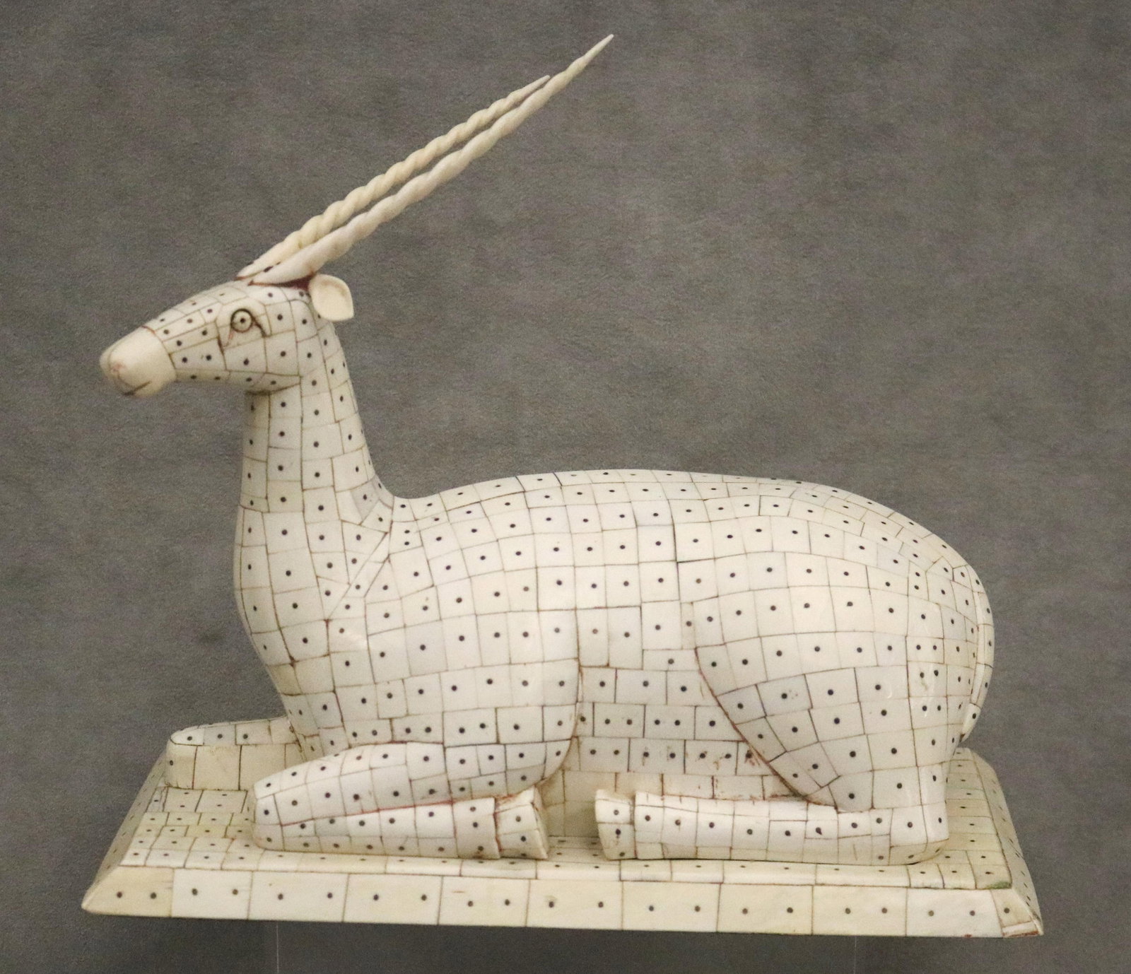 FIGURE OF ANTELOPE OR GAZELLE, COVERED IN TILED PATTERN - H: 10 1/2 in. Base, 10 1/2 in. x 5 1/2: FIGURE OF ANTELOPE OR GAZELLE, COVERED IN TILED PATTERN Bone or bone-like material. H: 10 1/2 in. Base, 10 1/2 in. x 5 1/2 in.