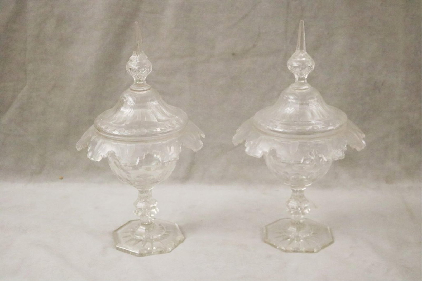 PAIR 19TH CENTURY CUT COLORLESS LIFT-COVER PEDESTAL-BASE COMPOTES - Height: 15 1/4".: PAIR 19TH CENTURY CUT COLORLESS LIFT-COVER PEDESTAL-BASE COMPOTES Domed covers with spire form finials; Height: 15 1/4"