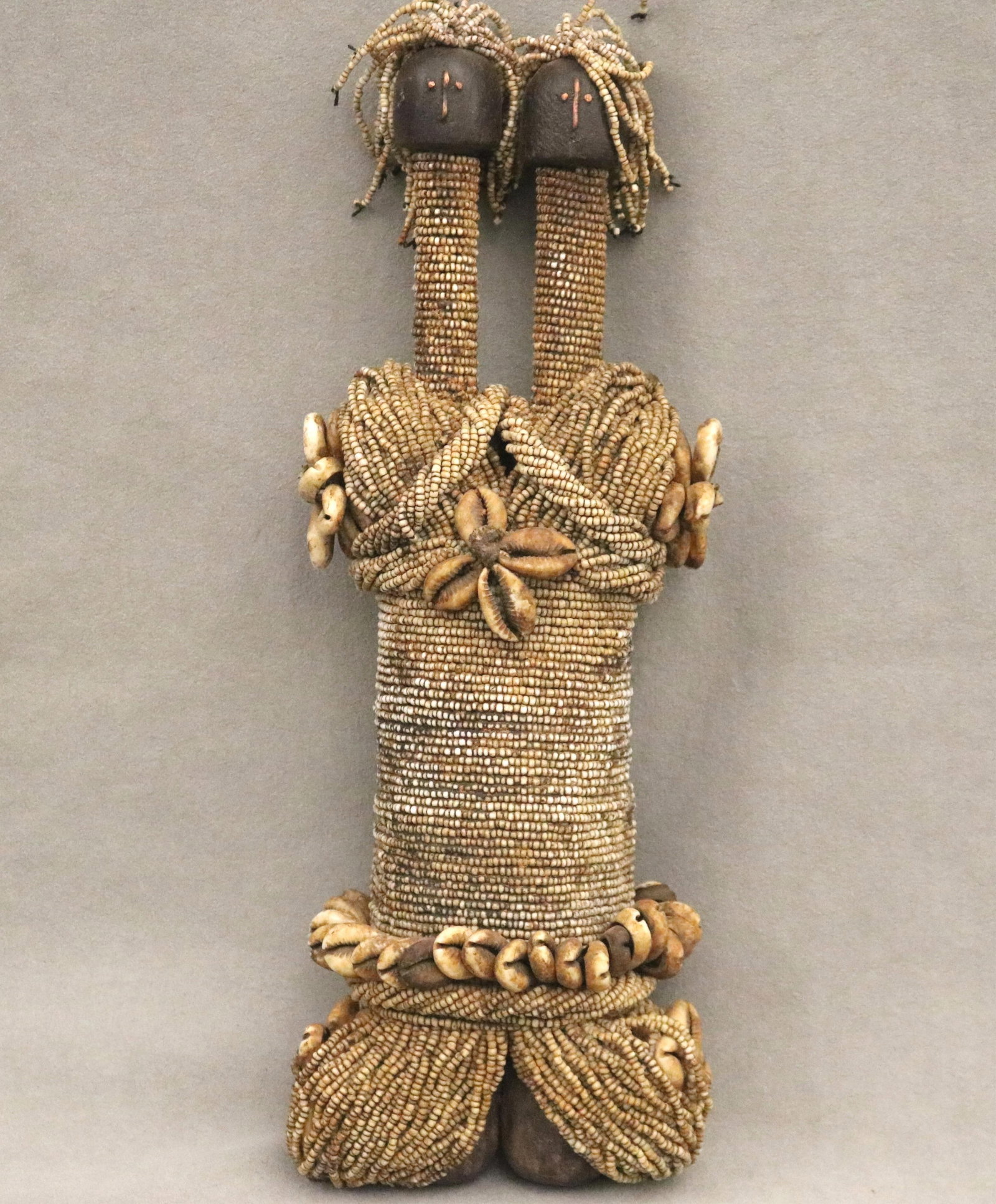 CAMEROONEAN FALI DUAL HEADED RITUAL DOLL - height: 13 inches.: CAMEROONEAN FALI DUAL HEADED RITUAL DOLL This Fali ritual doll from northern Cameroon is a distinctive fertility figure characterized by its dense, meticulous ornamentation and symbolic form. Hand-con