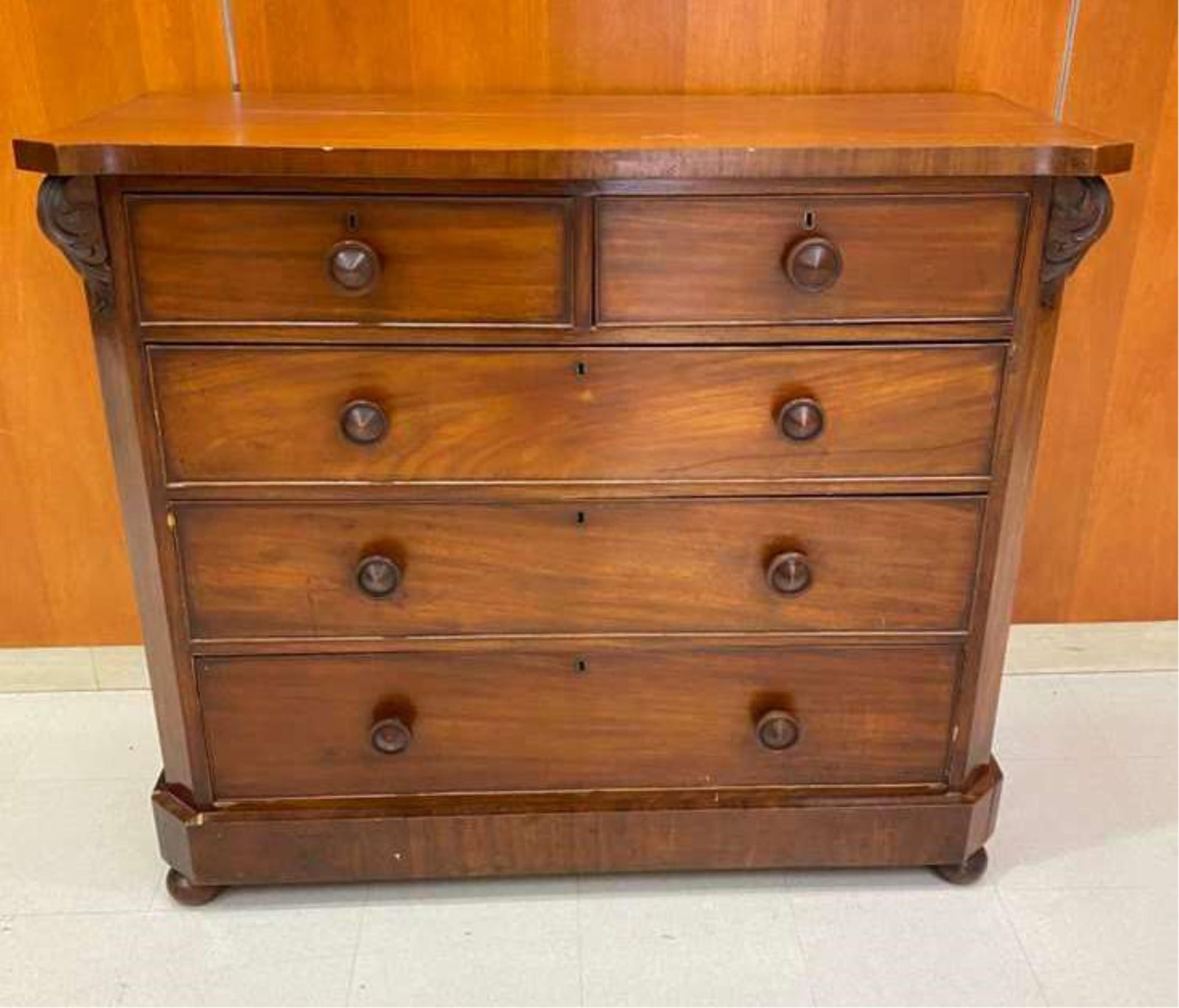 VICTORIAN MAHOGANY FIVE-DRAWER CHEST - H: 41 3/4"; W: 48"; D: 20 1/4"..: VICTORIAN MAHOGANY FIVE-DRAWER CHEST Shaped slab top projects over two aligned above three full-width drawers; leaf carved canted corners bun feet. H: 41 3/4"; W: 48"; D: 20 1/4".