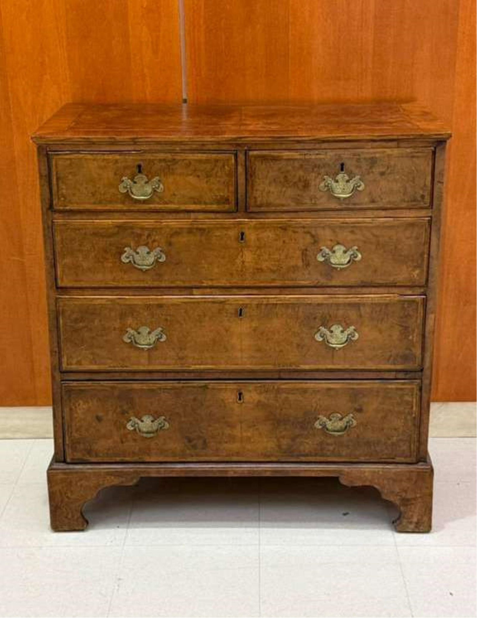 GEORGIAN WALNUT FIVE-DRAWER CHEST WITH HERRINGBONE INLAY - H: 35 7/8". W: 33 1/2". D: 17 1/2"..: GEORGIAN WALNUT FIVE-DRAWER CHEST WITH HERRINGBONE INLAY Rectangular top projects over two aligned half-width drawers above three graduated full width drawers; bracket feet. H: 35 7/8". W: 33 1/2". D: