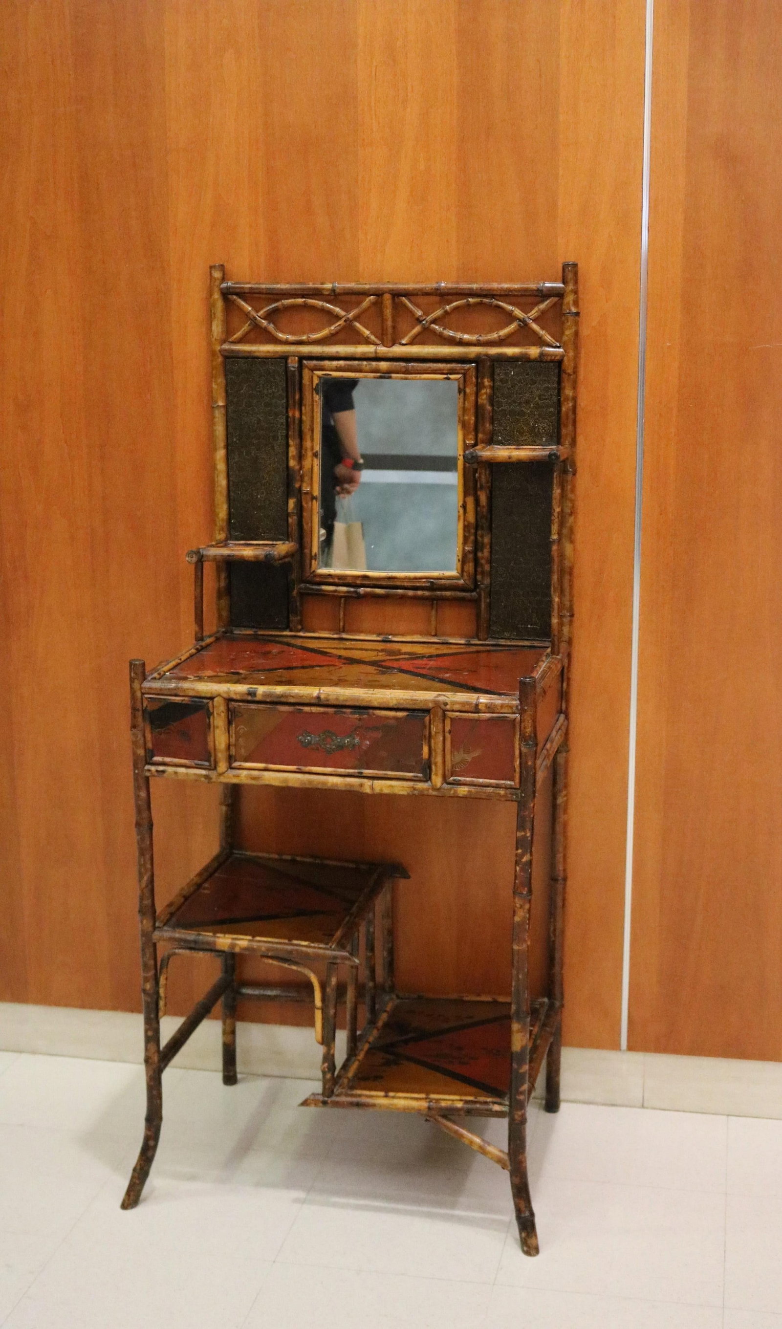 SCORCHED BAMBOO AND RED AND BLACK LACQUERED DRESSING STAND late 19th century - H: 52 3/4 in. W: 21: SCORCHED BAMBOO AND RED AND BLACK LACQUERED DRESSING STAND late 19th century Rectangular top supports mirror back panel; staggered shelves; painted bird and flower decoration H: 52 3/4 in. W: 21 7/8 i