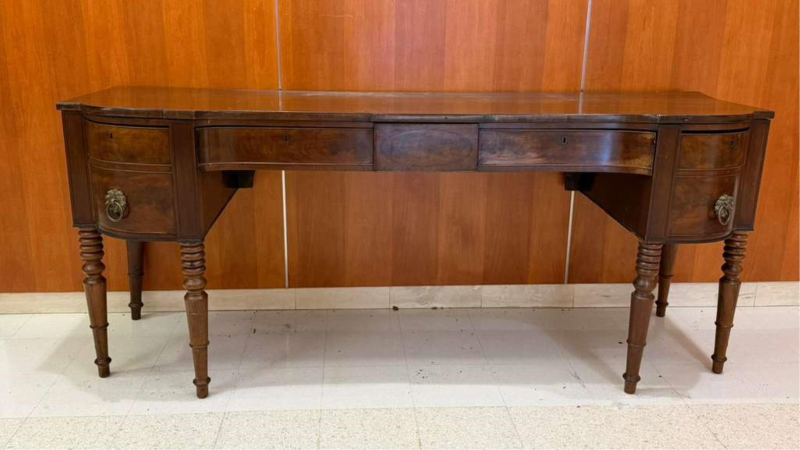 AMERICAN LATE FEDERAL MAHOGANY SIDEBOARD - H: 37 1/2". W: 89 3/4". D: 29 1/2"..: AMERICAN LATE FEDERAL MAHOGANY SIDEBOARD Rectangular top with shaped ends projects over concealed central small drawer with inlaid table, flanted by pair shaped-front apron drawers and pair bow front