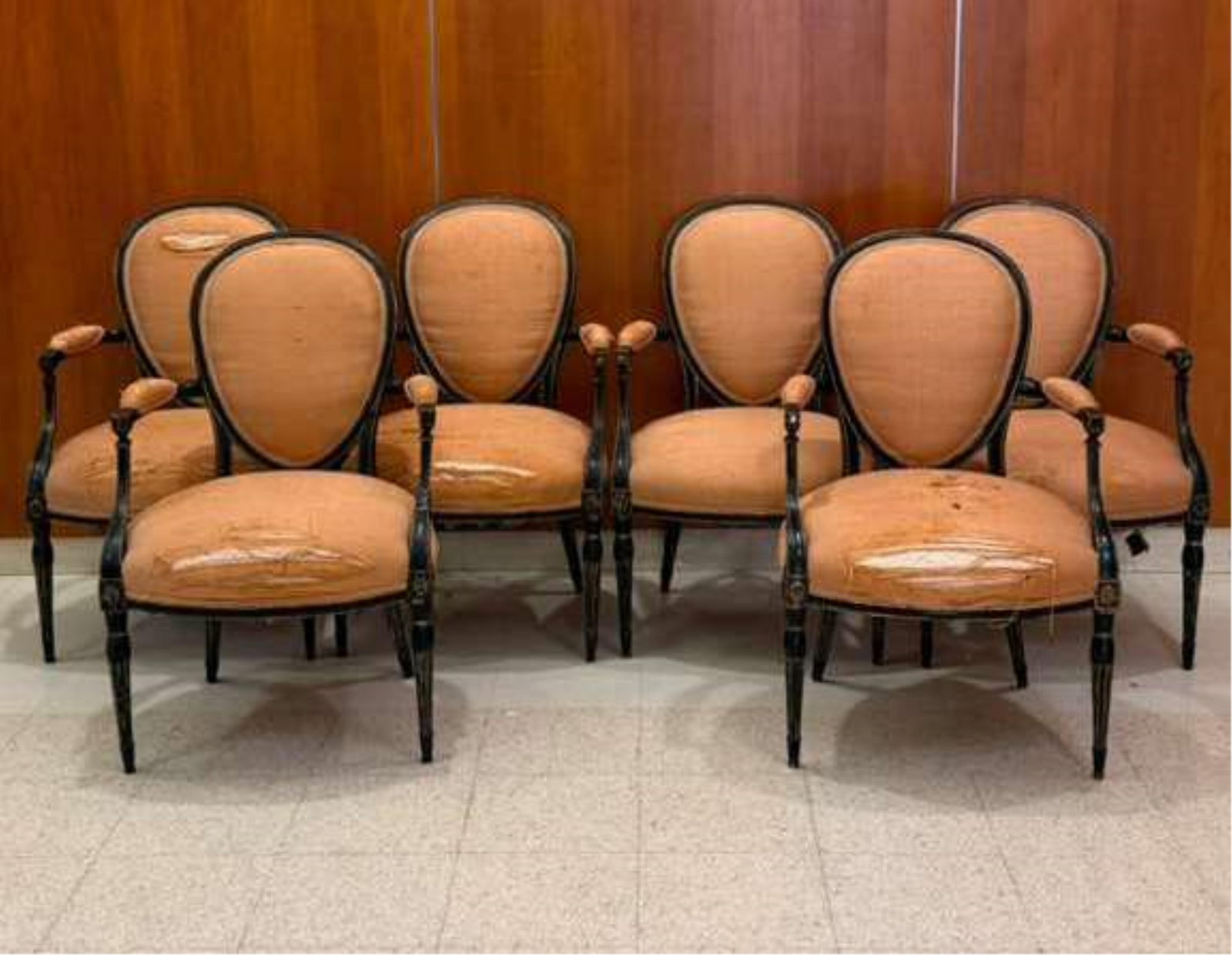 SET OF SIX LOUIS XVI BLACK-PAINTED OPEN-ARM CHAIRS WITH PEACH COLOR FABRIC UPHOLSTERED OVOID BACK: SET OF SIX LOUIS XVI BLACK-PAINTED OPEN-ARM CHAIRS WITH PEACH COLOR FABRIC UPHOLSTERED OVOID BACK PANELS, SEATS AND ARM RESTS (Imperfections).