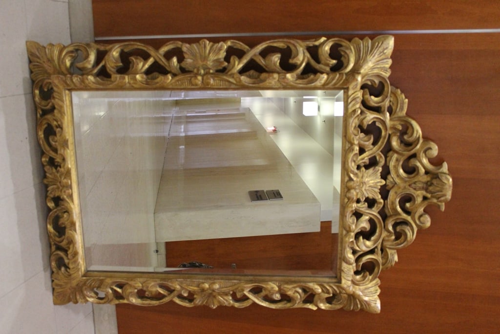 GILT FRAMED 18TH CENTURY STYLE RECTANGULAR WALL MIRROR WITH SCROLLING, PIERCED FRAME AND DOMED: GILT FRAMED 18TH CENTURY STYLE RECTANGULAR WALL MIRROR WITH SCROLLING, PIERCED FRAME AND DOMED CREST. Beveled glass - H: 52 in. W: 36 1/2 in.