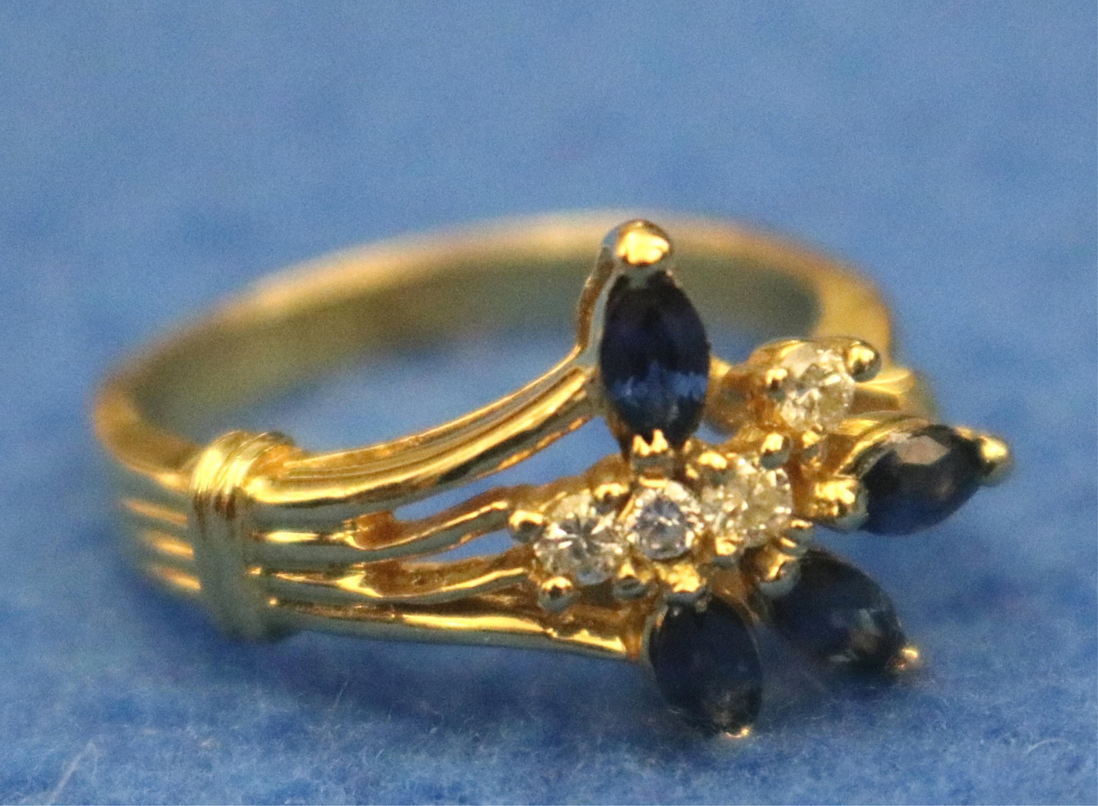 14K YELLOW GOLD, DIAMOND AND SAPPHIRE SPRAY DESIGN RING - Ring size: 6 3/4. Gross wt. 2 dwt.: 14K YELLOW GOLD, DIAMOND AND SAPPHIRE SPRAY DESIGN RING Four round diamonds and four marquise sapphires in asymmetrical bright-polished setting Ring size: 6 3/4. Gross wt. 2 dwt