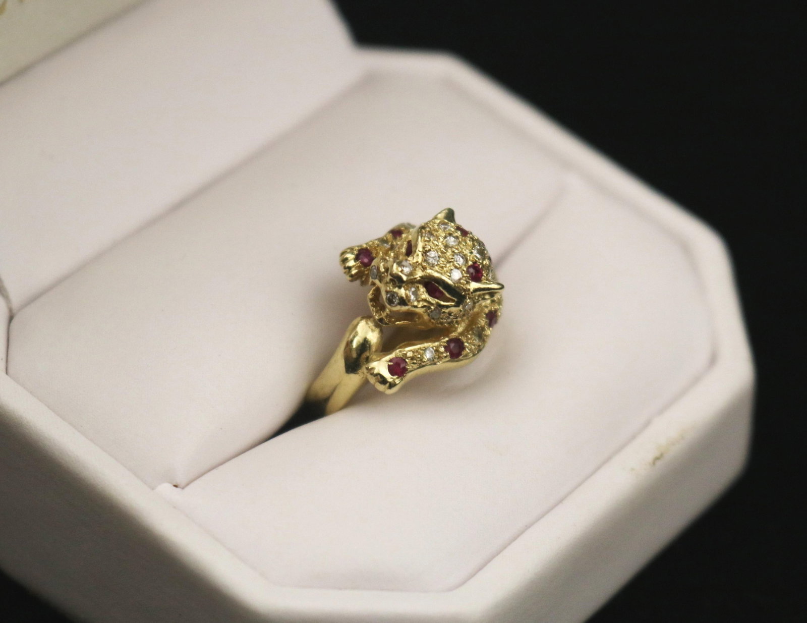 14K (585) YELLOW GOLD, RUBY AND DIAMOND LEOPARD DESIGN RING - Gross wt. 2 dwt. Ring Size: 3 1/4..: 14K (585) YELLOW GOLD, RUBY AND DIAMOND LEOPARD DESIGN RING Sculpted head and forearms of leopard pav?-set with numerous round diamonds and 16 round rubies. Gross wt. 2 dwt. Ring Size: 3 1/4.