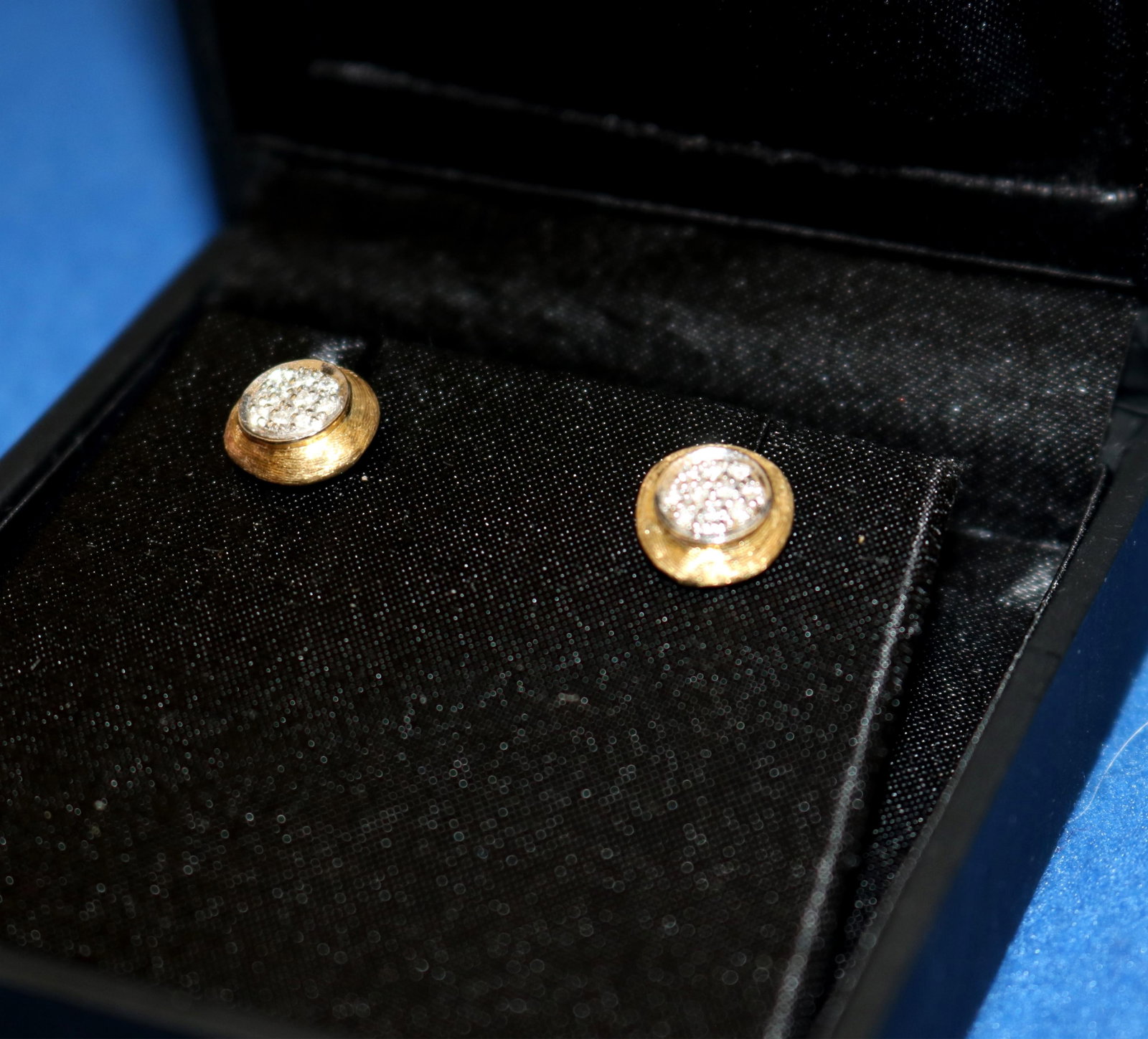 PAIR SIGNED MARCO BICEGO, ITALY, 18K (750) TEXTURED YELOW AND WHITE GOLD AND DIAMOND POST-BACK STUD: PAIR SIGNED MARCO BICEGO, ITALY, 18K (750) TEXTURED YELOW AND WHITE GOLD AND DIAMOND POST-BACK STUD EARRINGS Each circular gold stud centers cluster of ten matched round diamonds set in white gold Pan