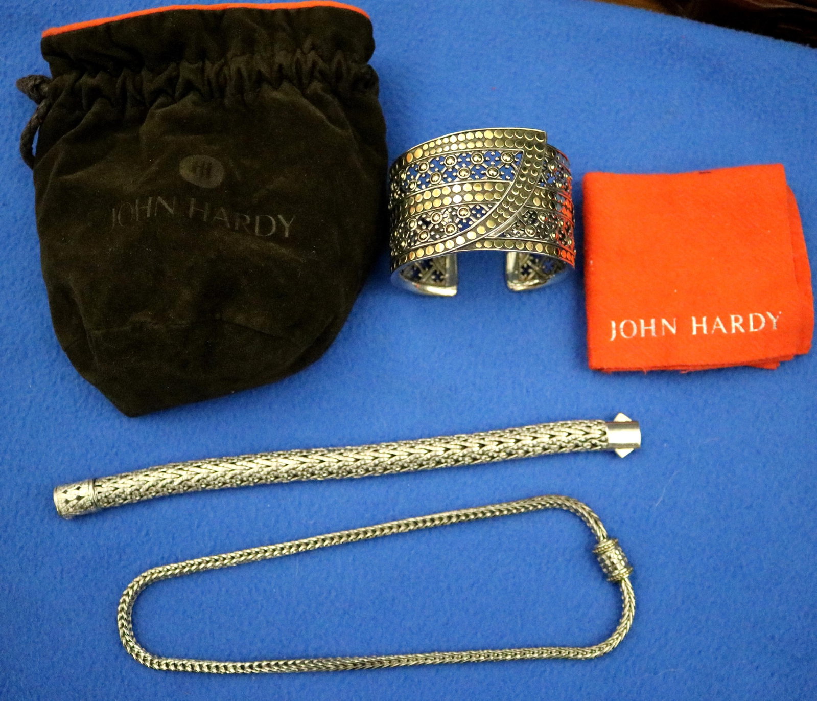 TWO SIGNED JOHN HARDY STERLING SILVER AND 18K GOLD BRACELETS AND A SIMILAR UNSIGNED CHOKER - .: TWO SIGNED JOHN HARDY STERLING SILVER AND 18K GOLD BRACELETS AND A SIMILAR UNSIGNED CHOKER Openwork cuff bracelet has overall yellow gold dot disc motif, W: 1 3/4 in., at widest point; woven-link tubu