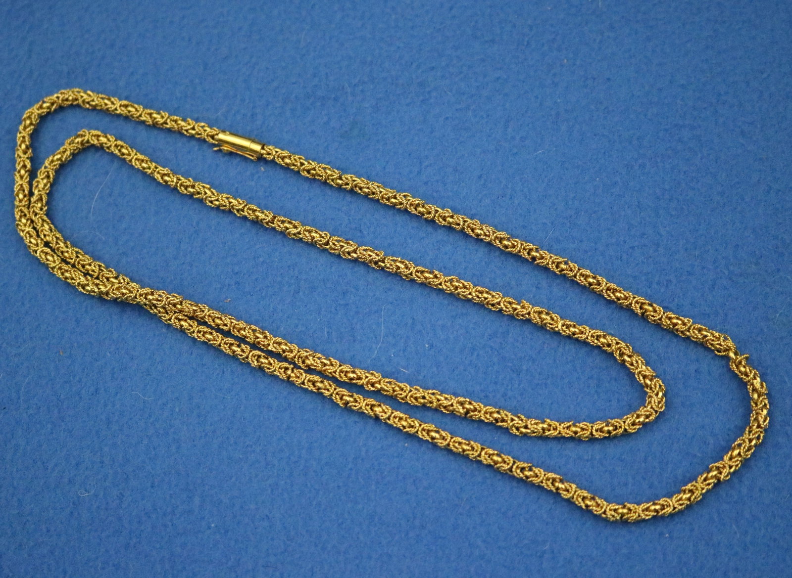 EGYPTIAN YELLOW GOLD OPENWORK WOVEN TUBULAR FLEXIBLE CHAIN NECKLACE - L: 36 1/2 in. W: 3/16 in. Wt.: EGYPTIAN YELLOW GOLD OPENWORK WOVEN TUBULAR FLEXIBLE CHAIN NECKLACE Stamped. Tubular tongue-and-groove clasp. L: 36 1/2 in. W: 3/16 in. Wt. 2 oz. 10 dwt.