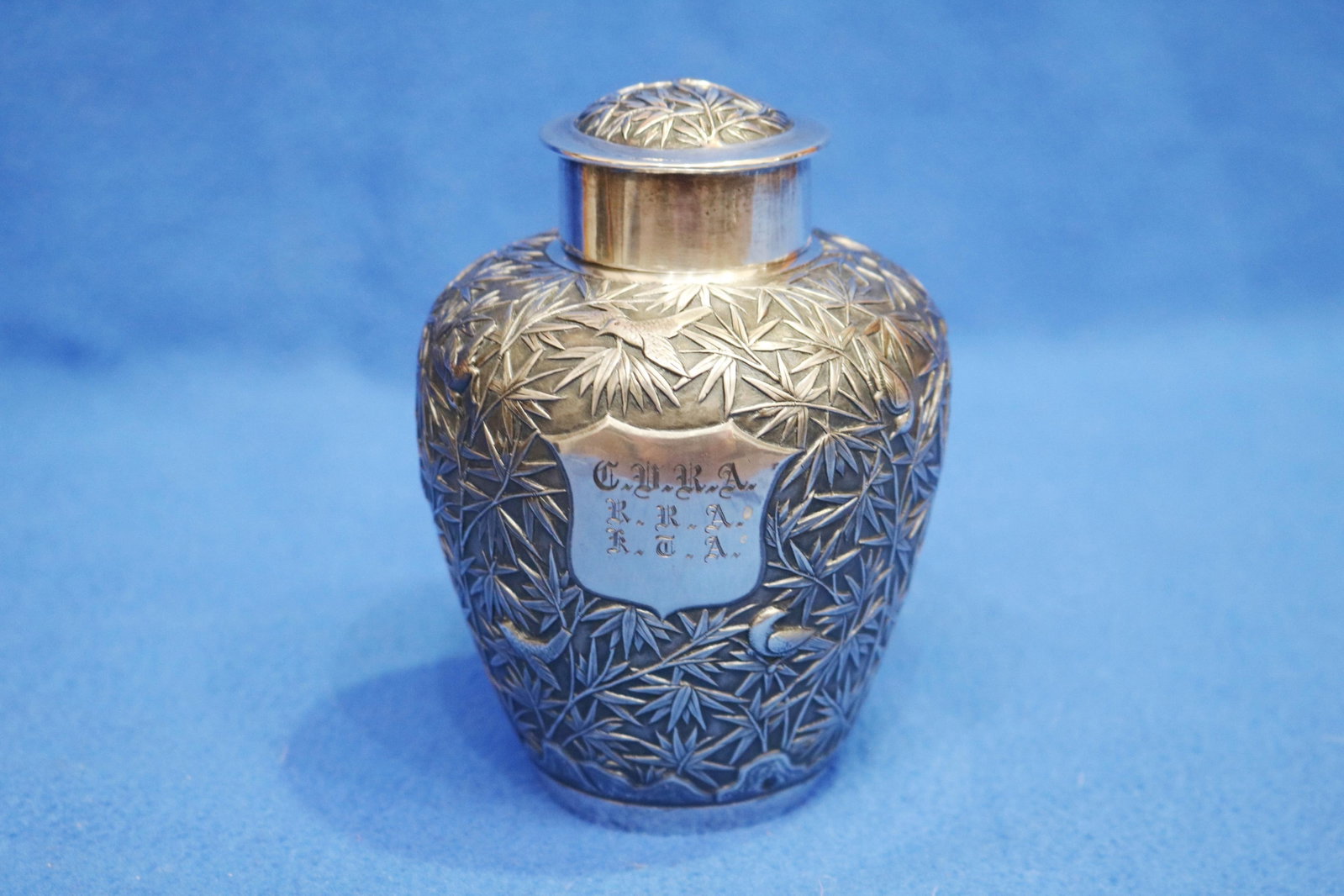 CHINESE SILVER OVOID TEACADDY WITH LIFT COVER late 19th-early 20th century - H: 5 1/4 in. Wt. 8 troy: CHINESE SILVER OVOID TEACADDY WITH LIFT COVER late 19th-early 20th century Signed with character mark and "CS" within punch. Overall relief bamboo with perched birds on stippled ground; raised shield