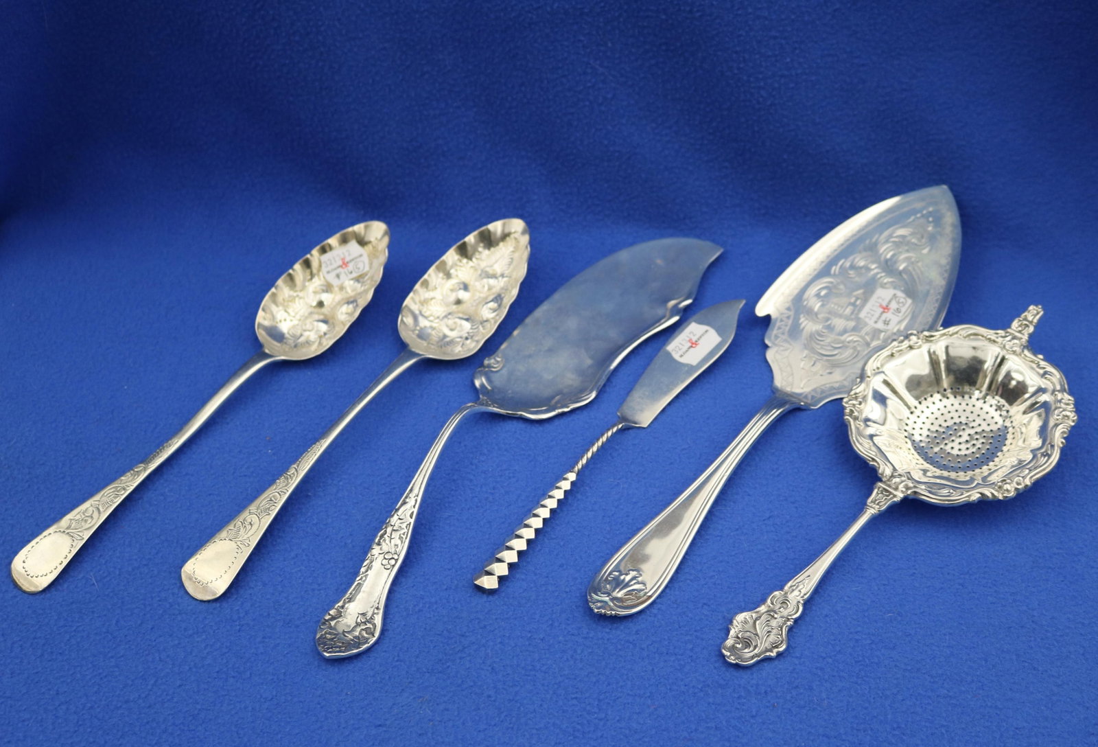 SIX ASSORTED SILVER SERVING IMPLEMENTS 19th and 20th century - Wt. 13.8 troy oz..: SIX ASSORTED SILVER SERVING IMPLEMENTS 19th and 20th century Including coin silver pastry trowel by J.T. & E.M. Edwards, two Georgian berry spoons, Dominick & Haff master butter knife, Mexican flat se