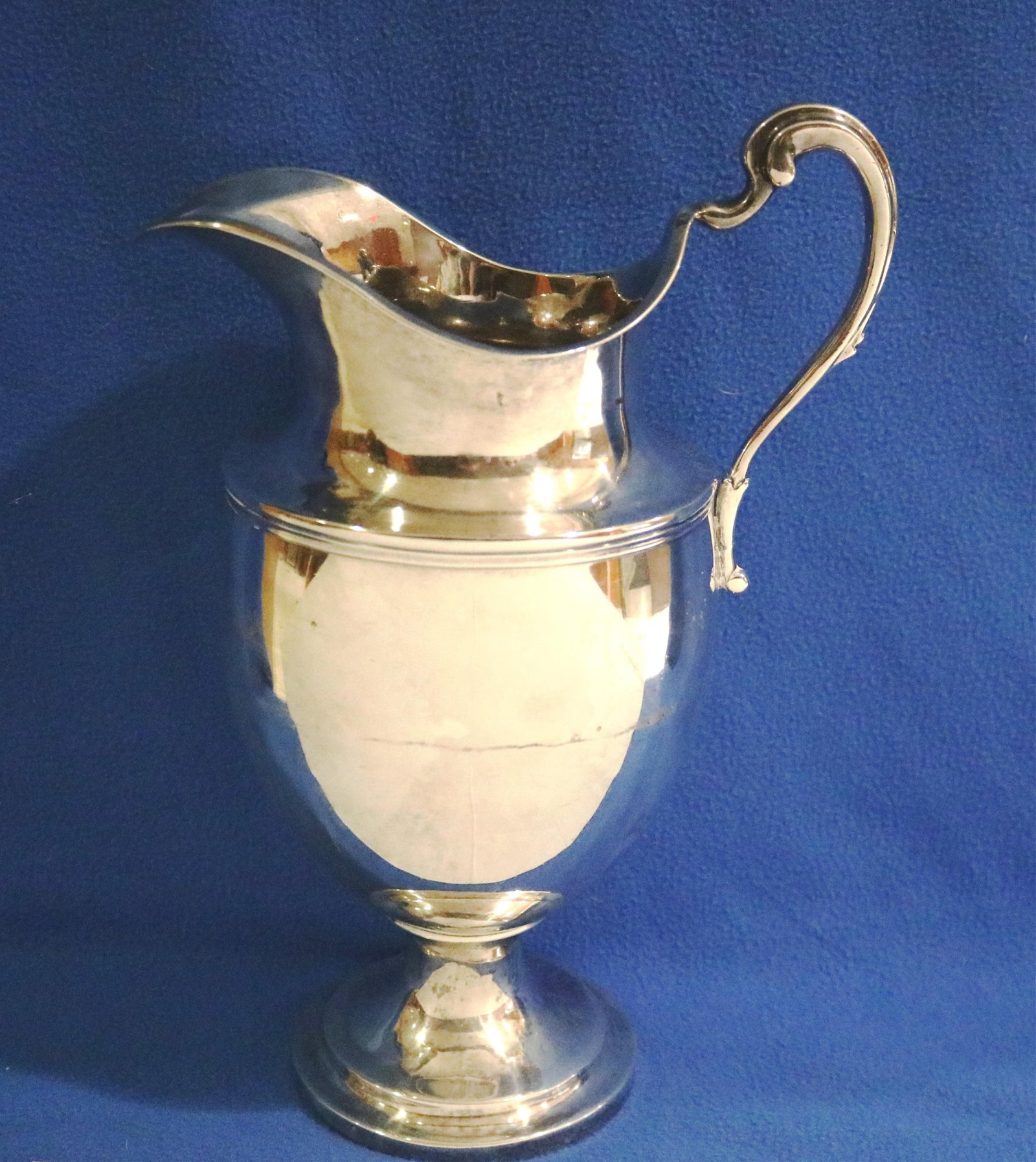AMERICAN COIN SILVER URN-FORM PEDESTAL-BASE WATER PITCHER 19th century - H: 12 1/4 in. Wt. 38.2 troy: AMERICAN COIN SILVER URN-FORM PEDESTAL-BASE WATER PITCHER 19th century Scrolling handle; ribbed collar band; unmarked (maker unknown) H: 12 1/4 in. Wt. 38.2 troy oz.