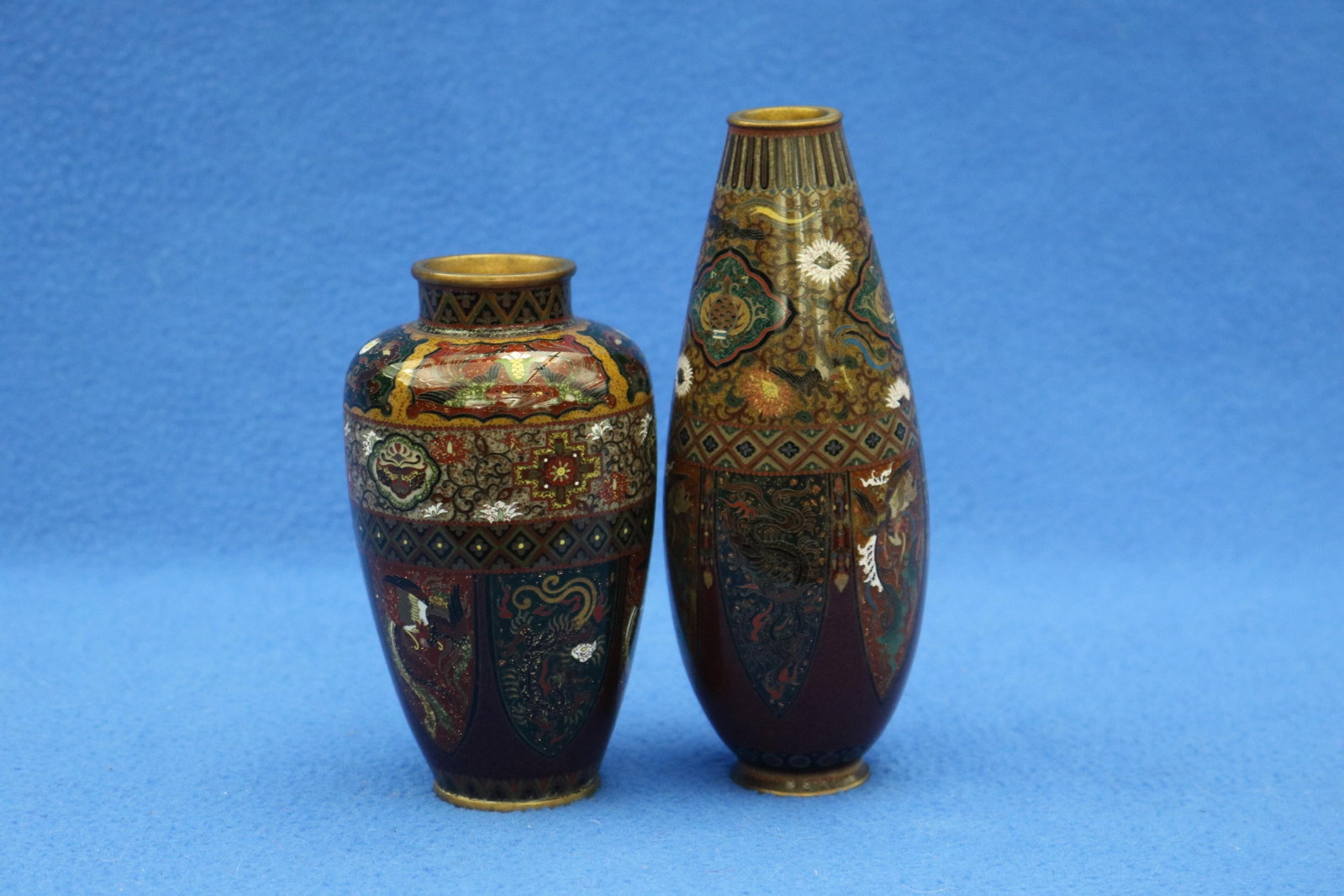 TWO JAPANESE CLOISONNE CABINET VASES late 19th-early 20th century - Taller, H: 6 in..: TWO JAPANESE CLOISONNE CABINET VASES late 19th-early 20th century One, elongated ovoid; other, ovoid with straight neck. Both finely decorated with panels of mythical birds and flowers on