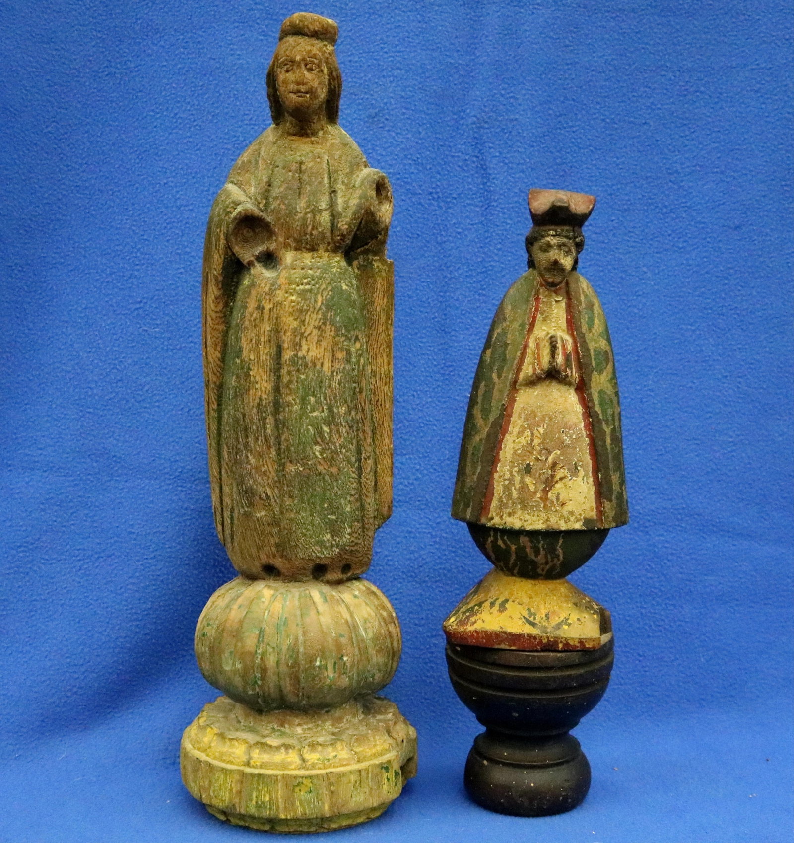 TWO HAND-CARVED RELIGIOUS FIGURINES OF DIFFERENT SCALES. - height (tallest statue including base):: TWO HAND-CARVED RELIGIOUS FIGURINES OF DIFFERENT SCALES. Two hand-carved religious figurines of different scales. The taller figure is carved from a light-colored wood with remnants of green and
