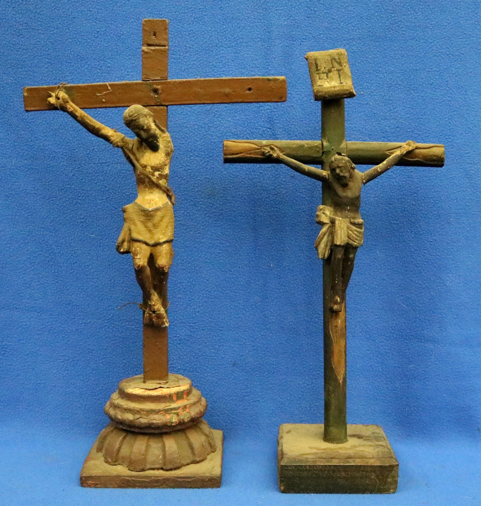 PAIR OF CRUCIFIXES FEATURING GUATEMALA'S BLACK CHRIST OF ESQUIPULAS - Height: (approx.) 18 inches.: PAIR OF CRUCIFIXES FEATURING GUATEMALA'S BLACK CHRIST OF ESQUIPULAS Pair of carved and polychromed wooden crucifixes featuring a primitive version of the Black Christ of Esquipulas (Cristo Negro) on t