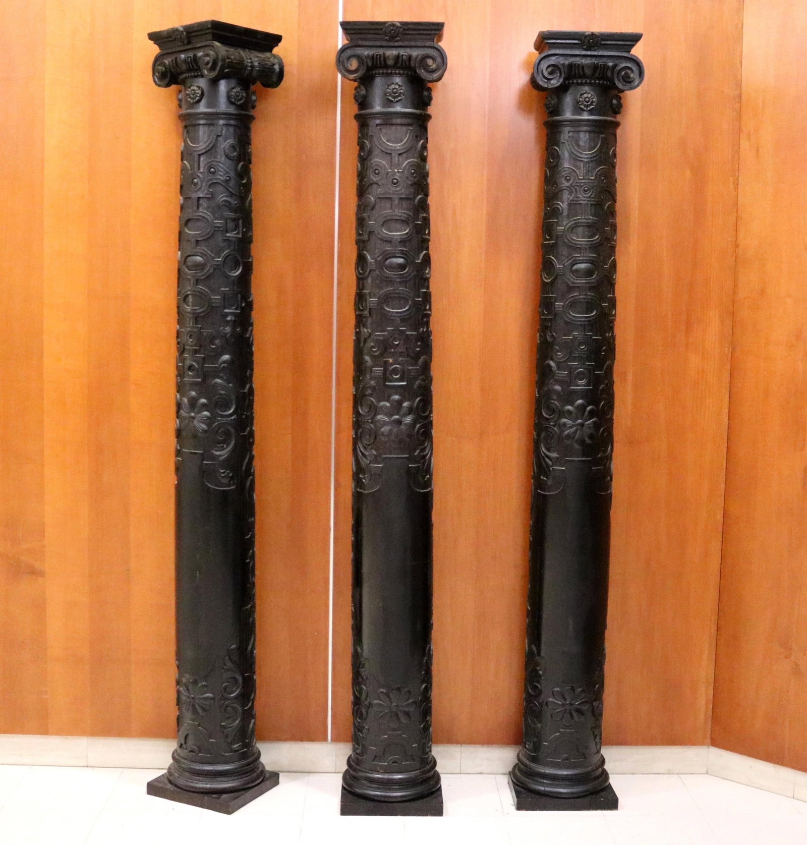SET THREE JACOBEAN REVIVAL STYLE CARVED AND EBONIZED OAK COLUMNS 19th century or earlier - H: 92 in.: SET THREE JACOBEAN REVIVAL STYLE CARVED AND EBONIZED OAK COLUMNS 19th century or earlier "Strapwork" pattern with linear geometric and delicate nailhead motifs; Ionic-inspired capitals with volutes an