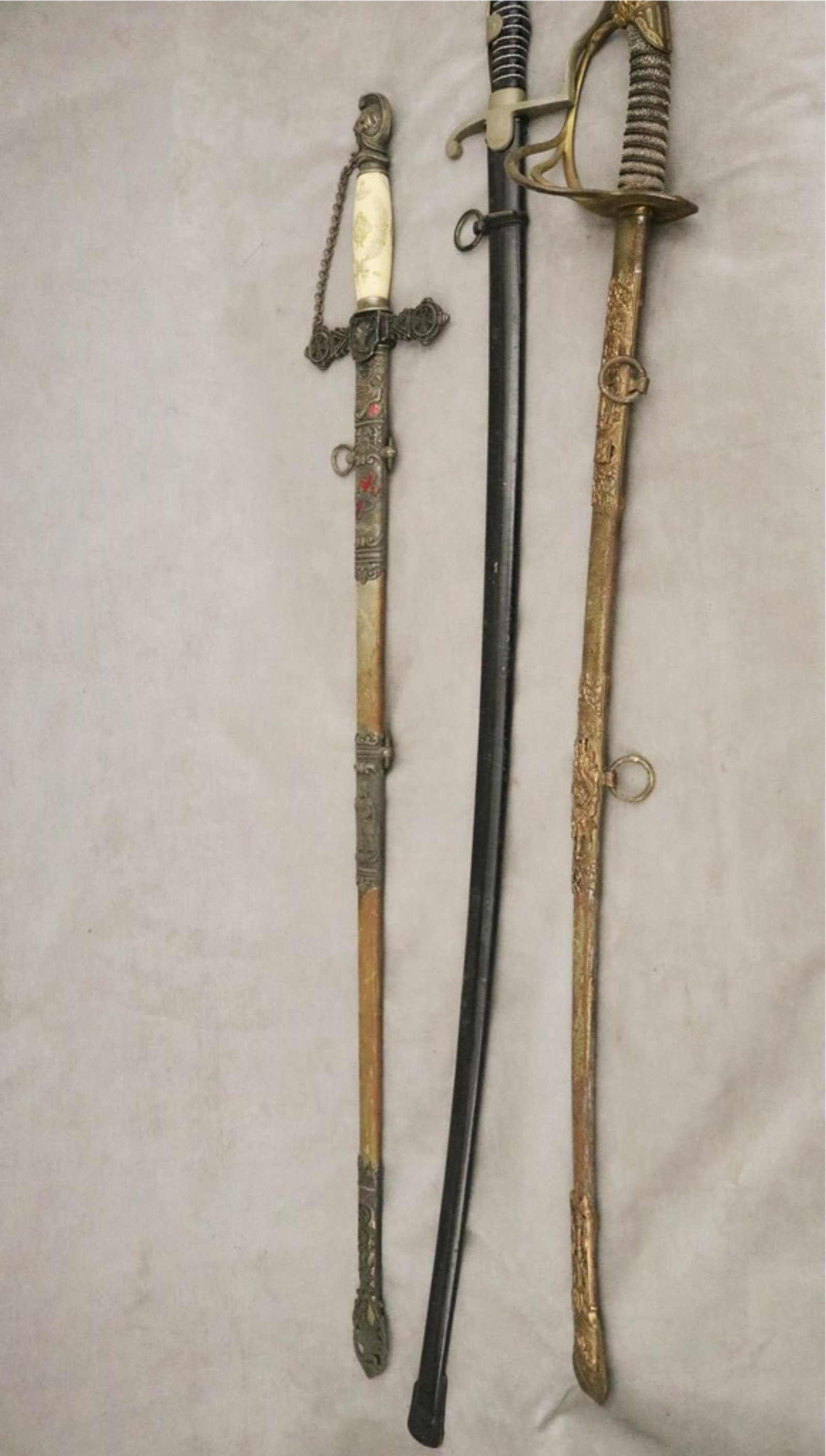 THREE CEREMONIAL VINTAGE SWORDS 19th century - Longest, L: 40 in..: THREE CEREMONIAL VINTAGE SWORDS 19th century Including one with etched bone hilt and red enameled decoration Longest, L: 40 in.