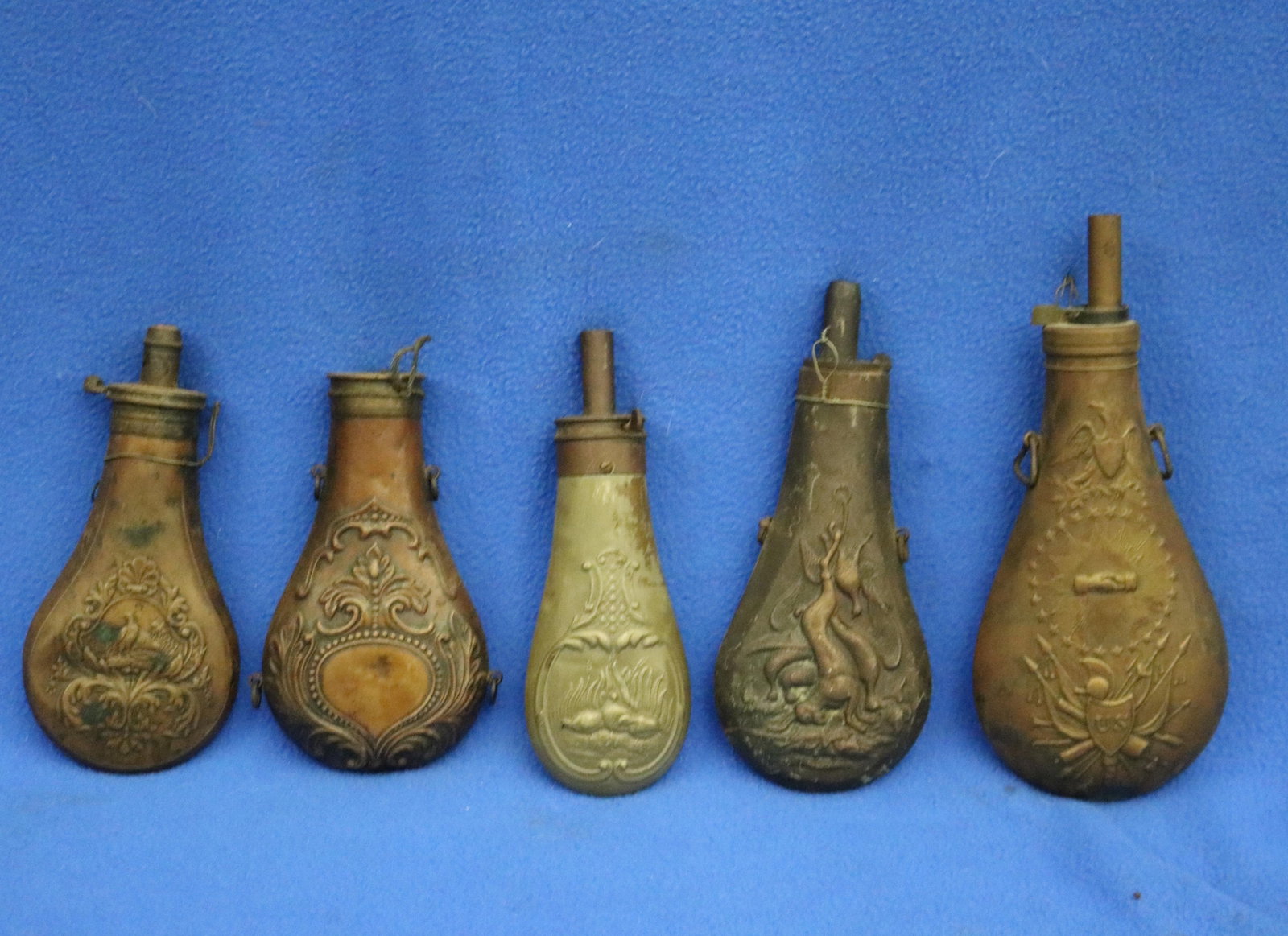 FIVE BRASS-MOUNTED EMBOSSED POWDER-FLASKS FOR ANTIQUE LONGARMS 19th century - . (1 of 18)