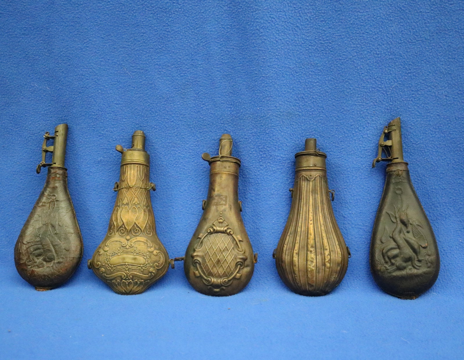 FIVE BRASS-MOUNTED EMBOSSED POWDER-FLASKS FOR ANTIQUE LONGARMS 19th century - . (1 of 15)