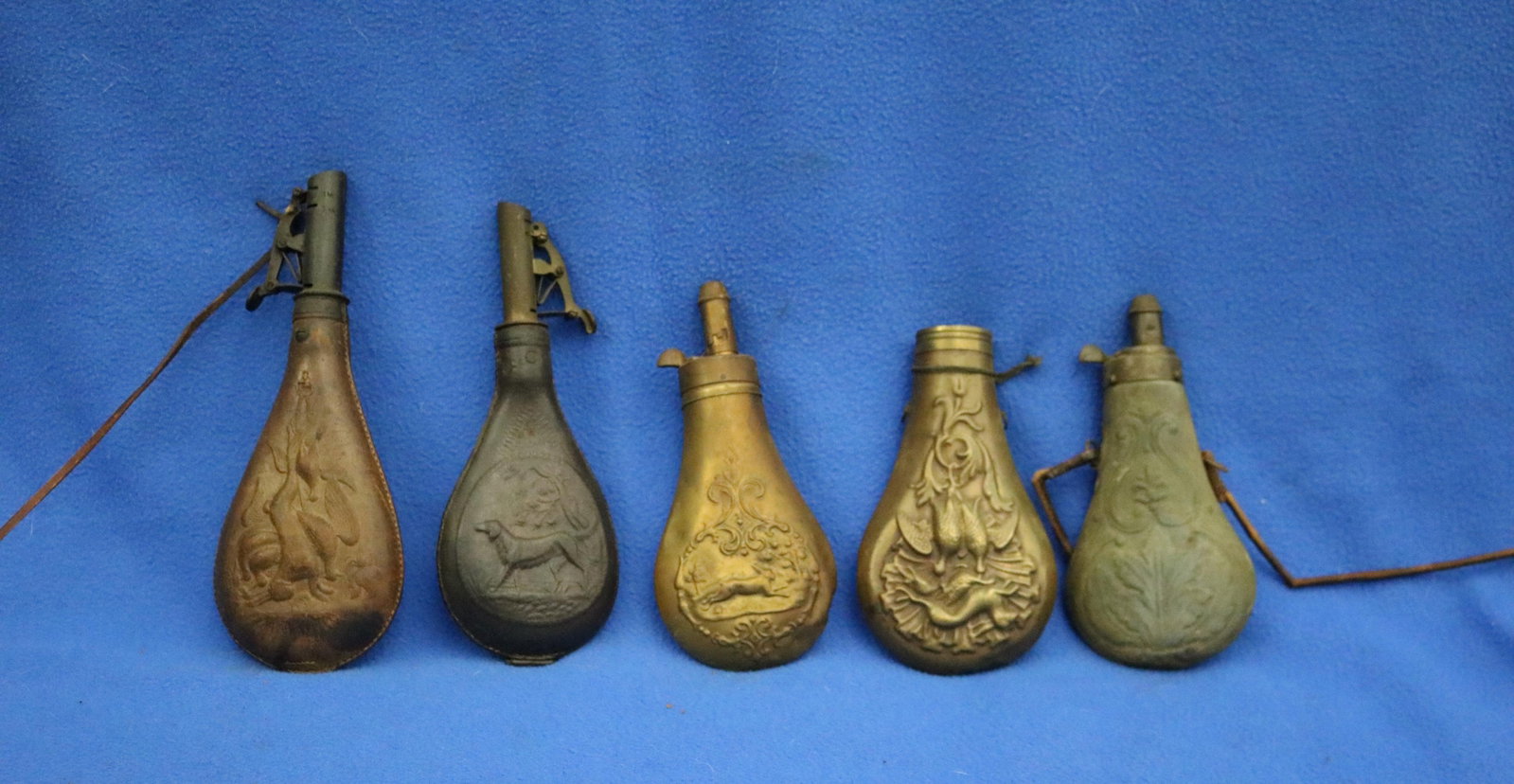 FIVE BRASS-MOUNTED EMBOSSED POWDER-FLASKS FOR ANTIQUE LONGARMS 19th century - . (1 of 15)