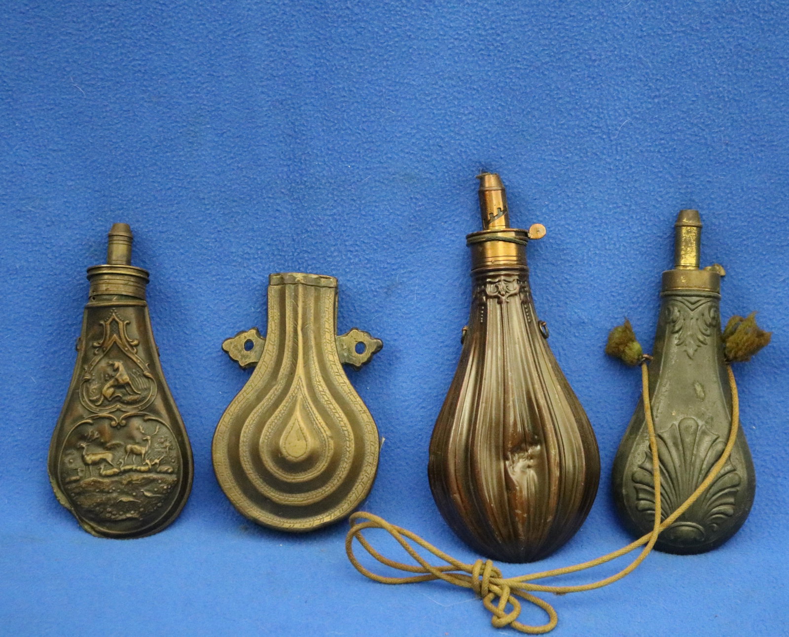 FOUR BRASS-MOUNTED EMBOSSED POWDER-FLASKS FOR ANTIQUE LONGARMS 19th century - . (1 of 13)