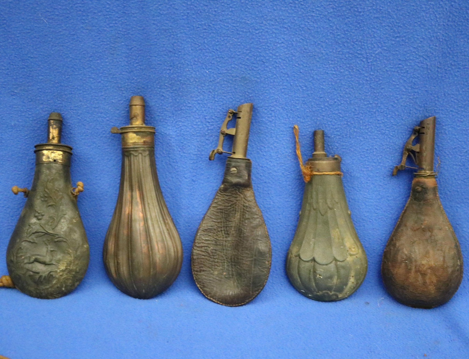 FIVE BRASS-MOUNTED EMBOSSED POWDER-FLASKS FOR ANTIQUE LONGARMS 19th century - . (1 of 15)