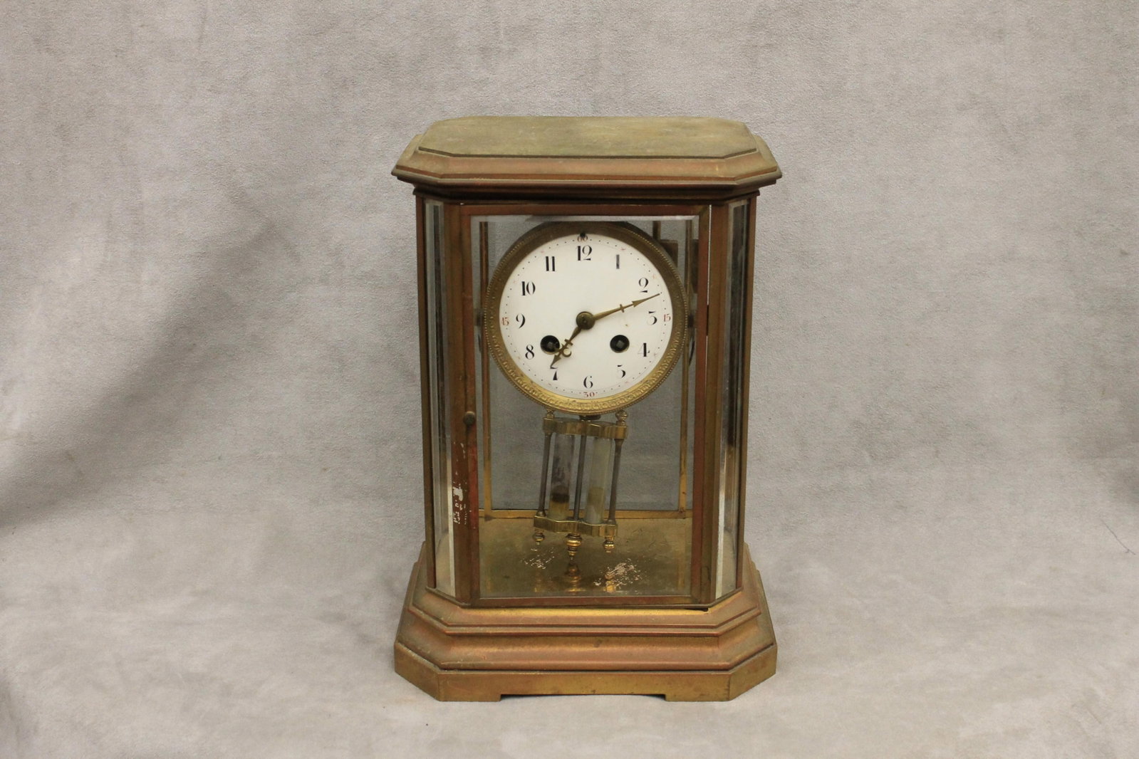 FRENCH BRASS AND GLASS VERTICAL RECTANGULAR PENDULUM MANTEL CLOCK early 20th century - Height: 12: FRENCH BRASS AND GLASS VERTICAL RECTANGULAR PENDULUM MANTEL CLOCK early 20th century Beveled panels; key-wind striking movement with key. Height: 12 1/6 in., 8 3/4 in. x 6 ½ in., base