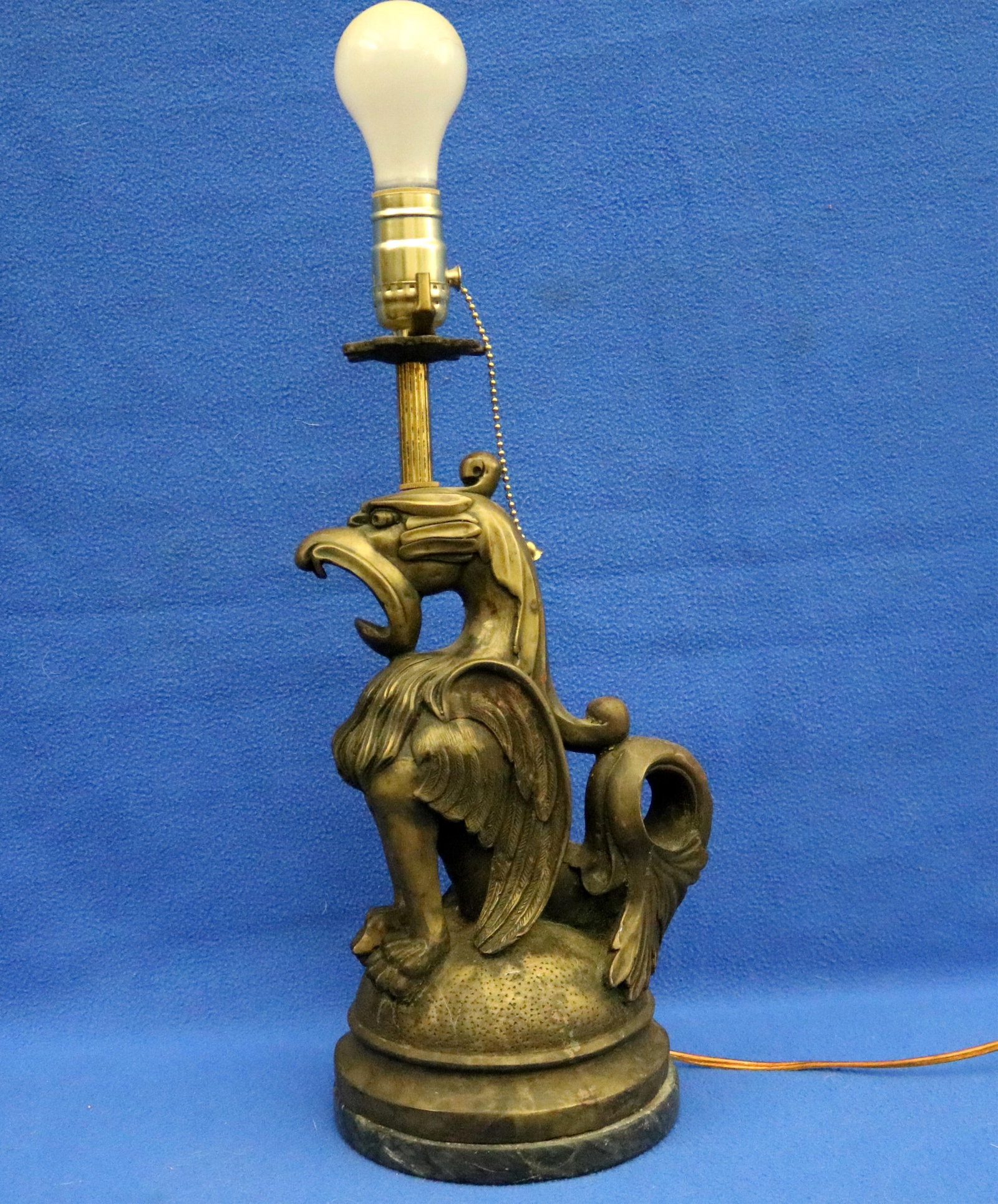 GOTHIC REVIVAL BRONZE LAMP CAST AS GRIFFIN (OR GRYPHON) - Overall, H: (including socket): 20 1/2: GOTHIC REVIVAL BRONZE LAMP CAST AS GRIFFIN (OR GRYPHON) Marble roundel base. Overall, H: (including socket): 20 1/2 in.