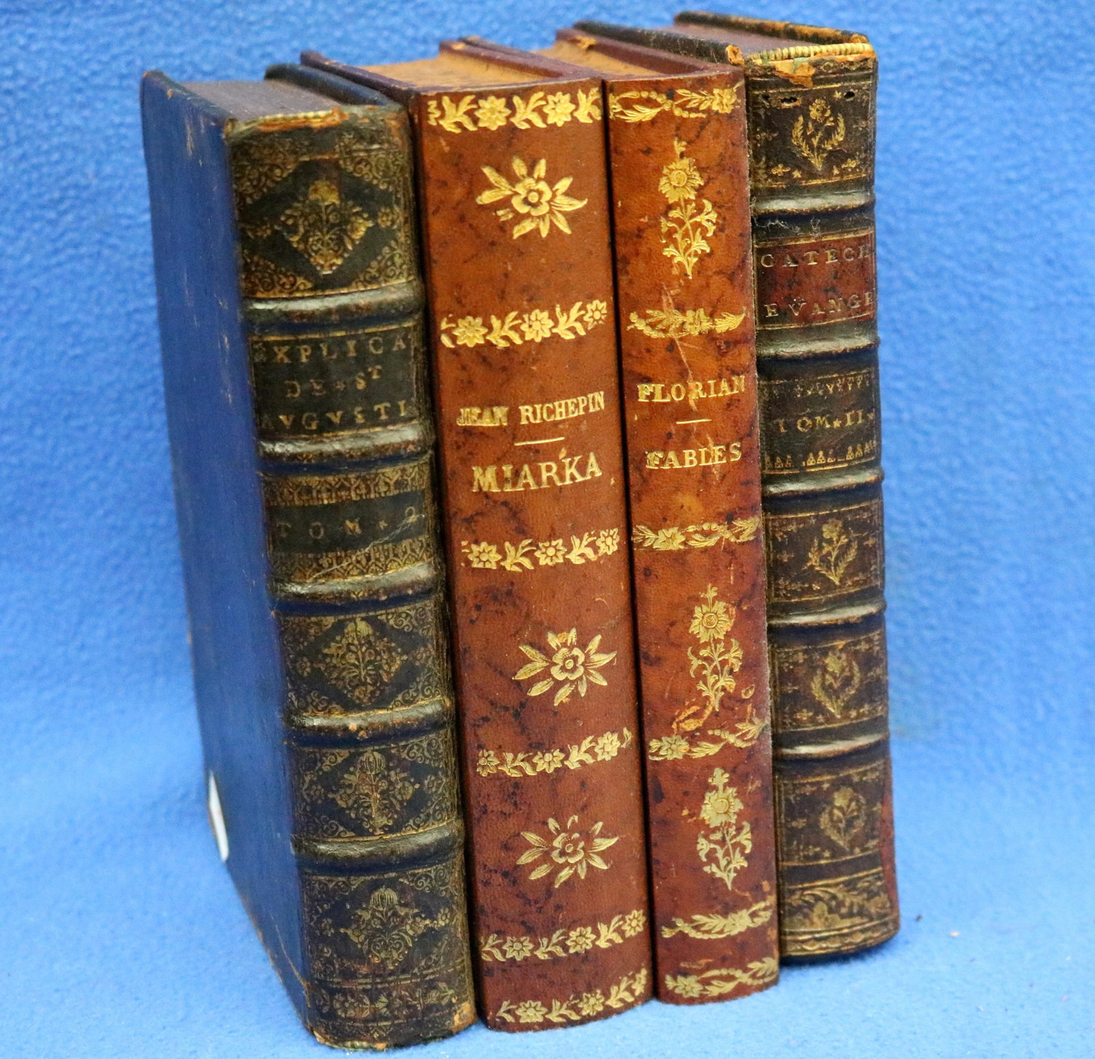 FRENCH TROMPE-L'OEIL BOOK LEATHER -BOUND HINGED-TOP BOOK BOX Marked "Made in France." - H: 5 1/2 in.: FRENCH TROMPE-L'OEIL BOOK LEATHER -BOUND HINGED-TOP BOOK BOX Marked "Made in France." Felt-lined compartment with precise circular and rectangular cut-outs, indicating it likely serving a tantalus or