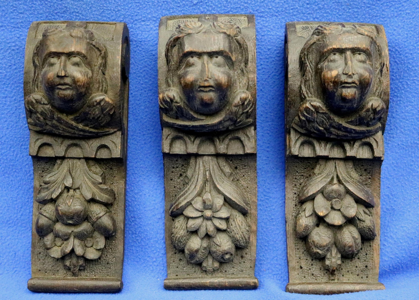 THREE SIMILAR GOTHIC REVIVAL STYLE DECORATIVE AND STRUCTURAL BRACKETS OR CORBELS - Height: 9 1/2: THREE SIMILAR GOTHIC REVIVAL STYLE DECORATIVE AND STRUCTURAL BRACKETS OR CORBELS Each features unique face at top, supported by ornate floral and foliage patterns at base. Height: 9 1/2 in.