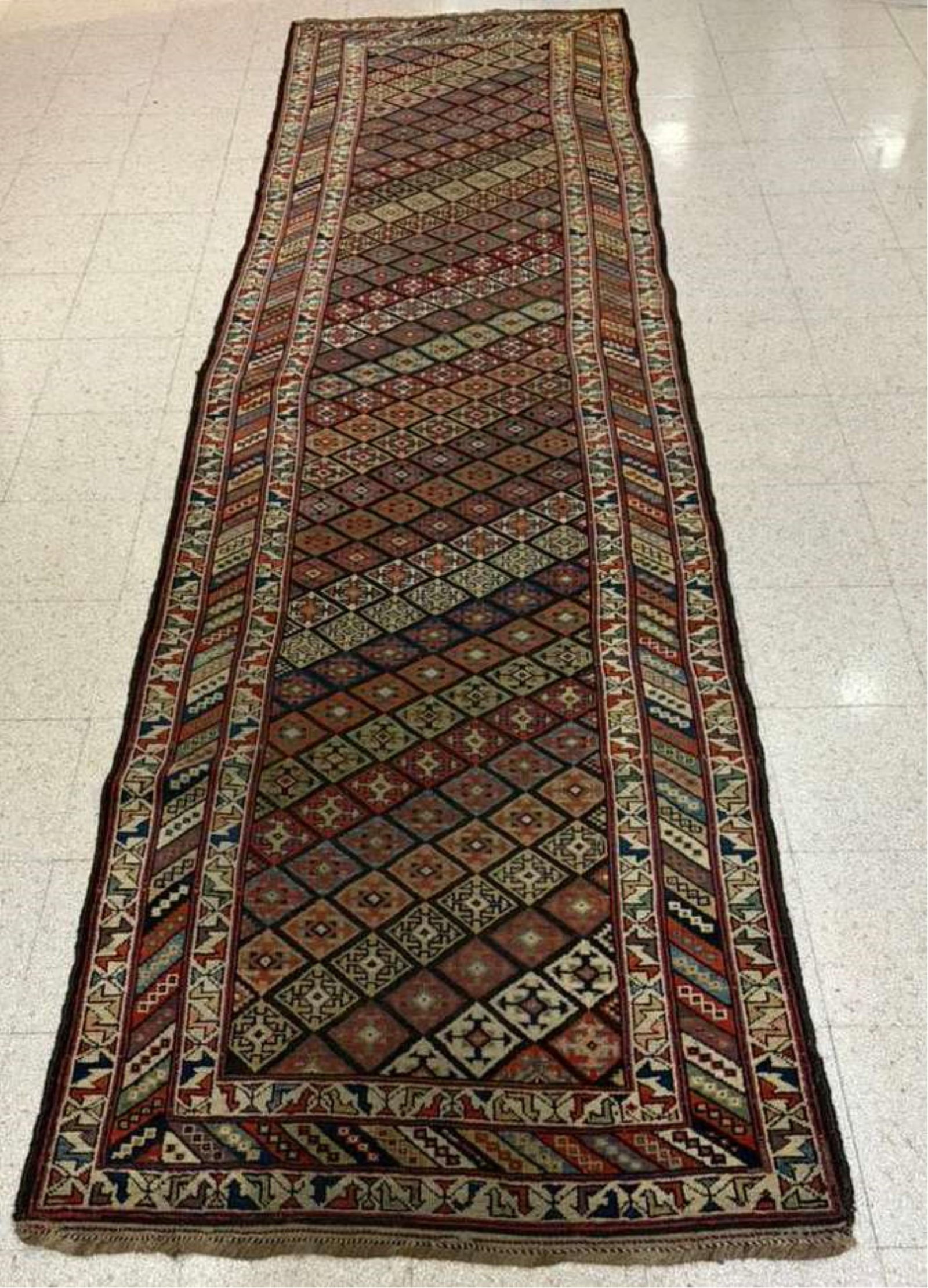KAZAK TRIBAL RUNNER - 13 ft. 1 in. x 3 ft. 9 in..: KAZAK TRIBAL RUNNER Diamond motifs configured in diagonal bands outlined by geometric banded border 13 ft. 1 in. x 3 ft. 9 in.