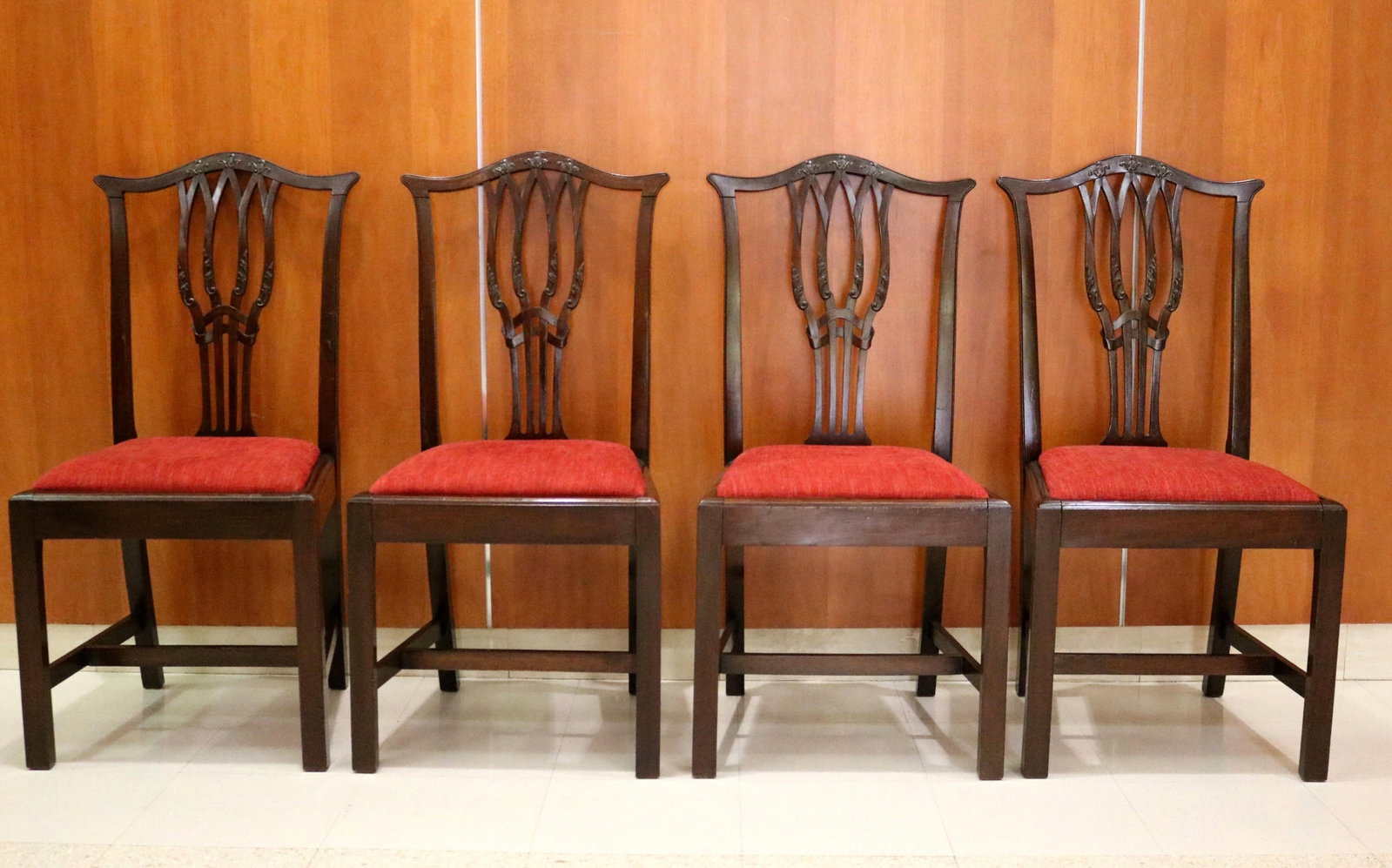 SET OF FOUR CHIPPENDALE-STYLE CARVED MAHOGANY SLIPSEAT SIDECHAIRS - .: SET OF FOUR CHIPPENDALE-STYLE CARVED MAHOGANY SLIPSEAT SIDECHAIRS Serpentine crests over leaf-carved, pierced splats; straight square legs joined by H-stretcher