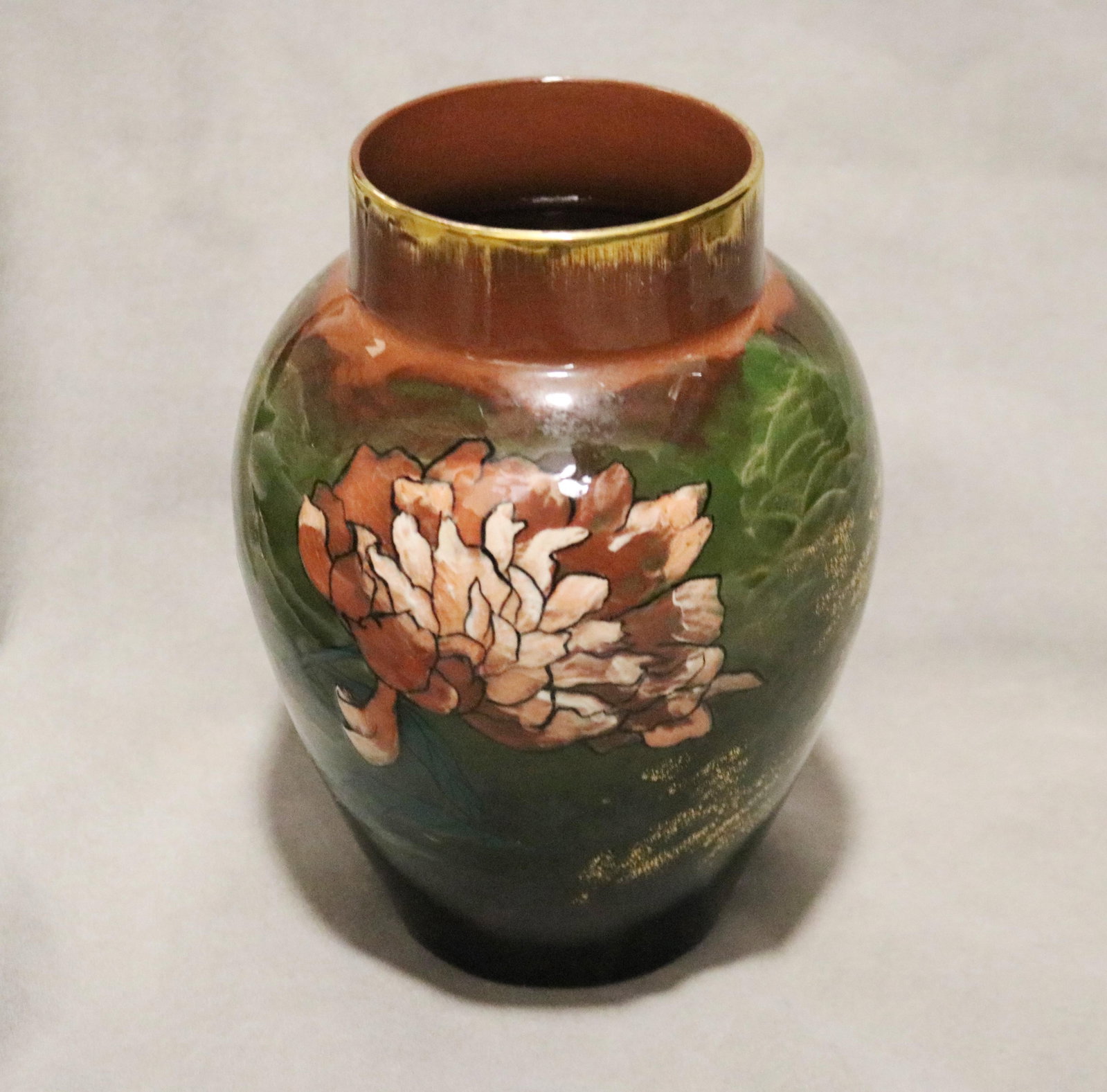ARTIST-SIGNED ROOKWOOD FLORAL PAINTED OVOID ART POTTERY VASE late 19th century - H: 11 in..: ARTIST-SIGNED ROOKWOOD FLORAL PAINTED OVOID ART POTTERY VASE late 19th century Signed with incised initials "H.H." Large floral blossom and butterflies, with gilt accents on mottled green ground. H: 1