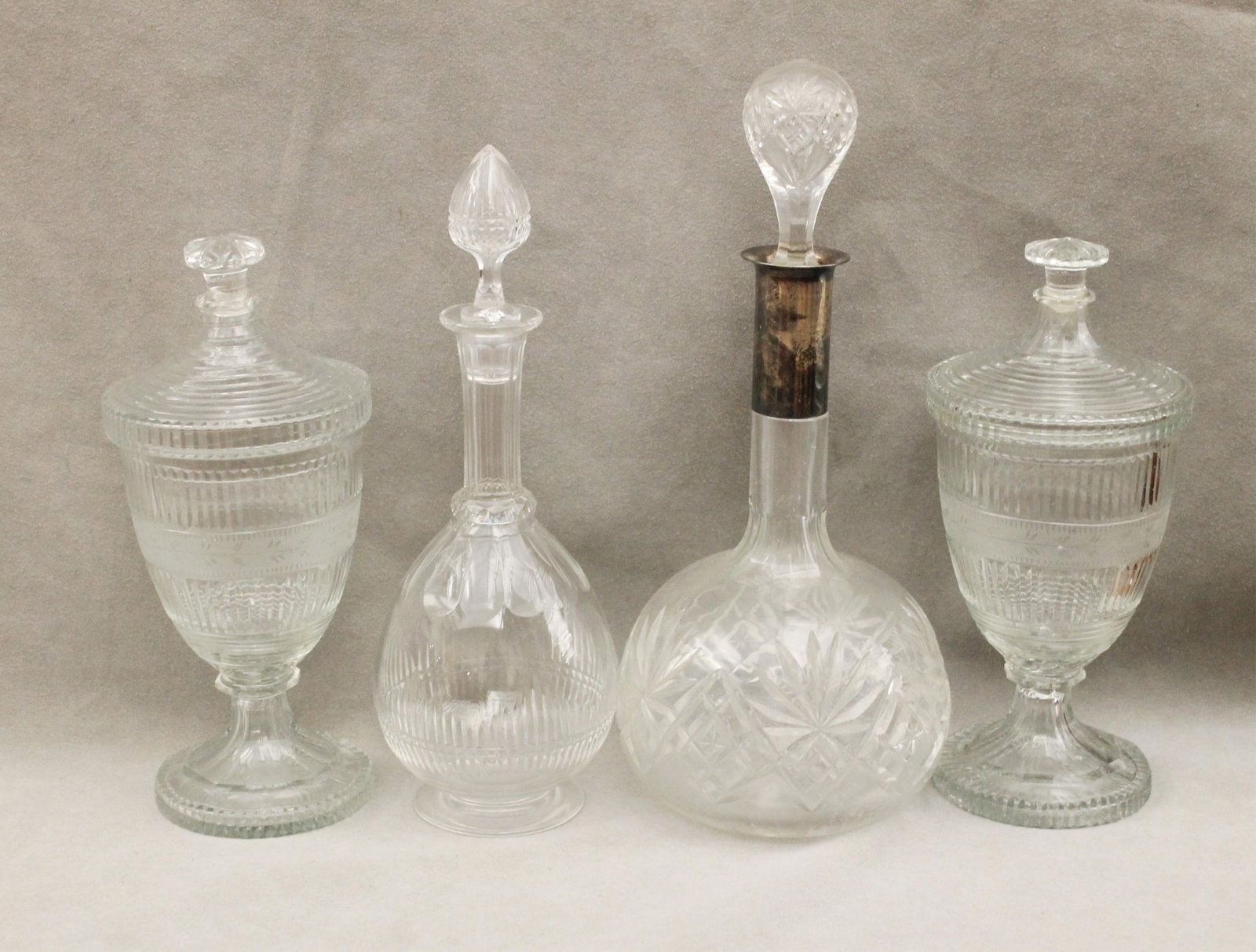 PAIR CUT COLORLESS CRYSTAL URN-FORM LIFT-COVER JARS, AND TWO CUT-CRYSTAL DECANTERS - H: 9 1/2 in.. (1 of 4)