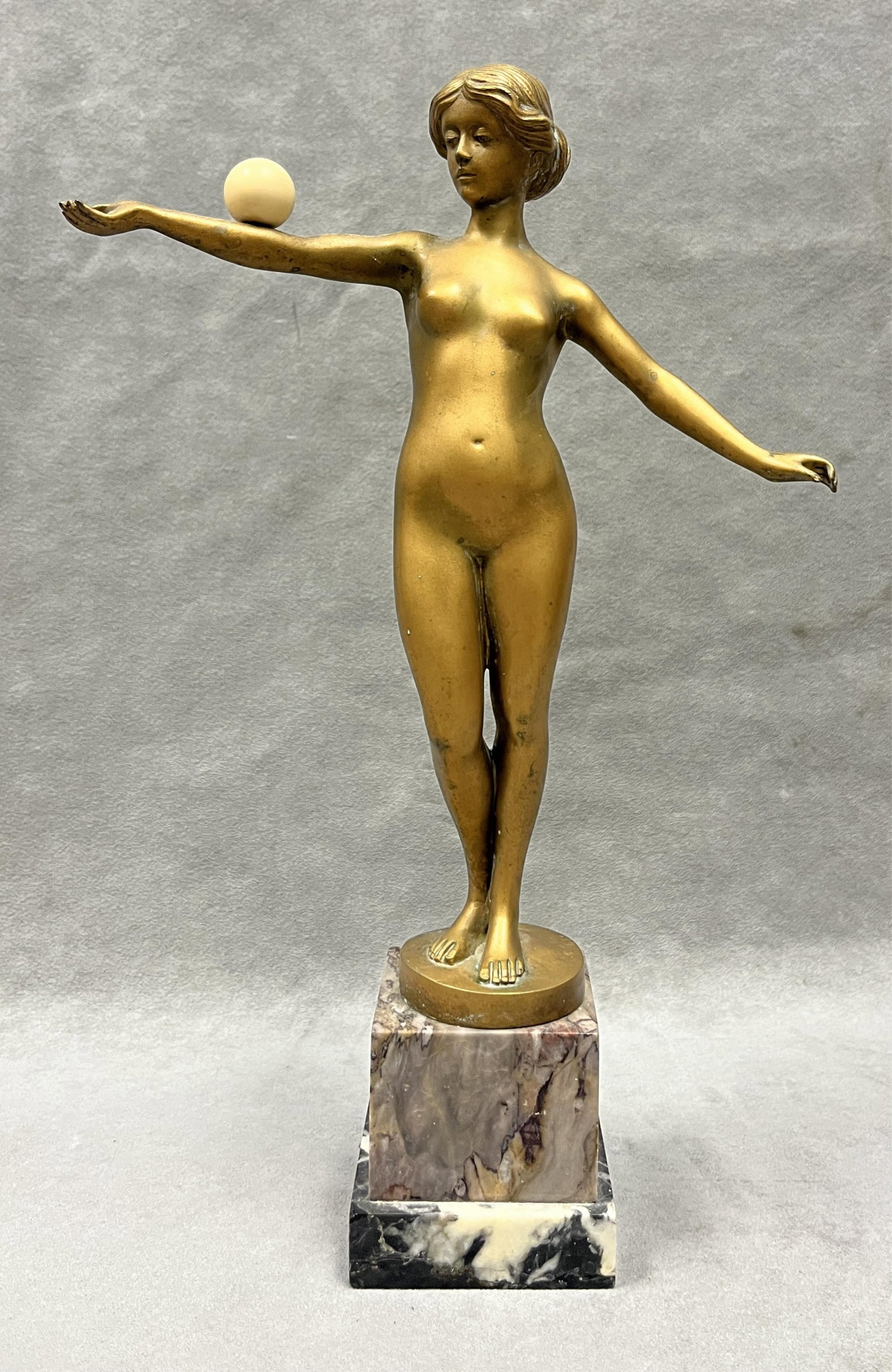 JULIUS PAUL SCHMIDT-FELLING (German, 1835?1920). Female Nude Balancing a Ball, Gilded bronze, H: 13: JULIUS PAUL SCHMIDT-FELLING German, 1835?1920 Female Nude Balancing a Ball Gilded bronze Figure with carved ball; incised signature; variegated marble base. H: 13 inches. PROVENANCE: ?Merry H