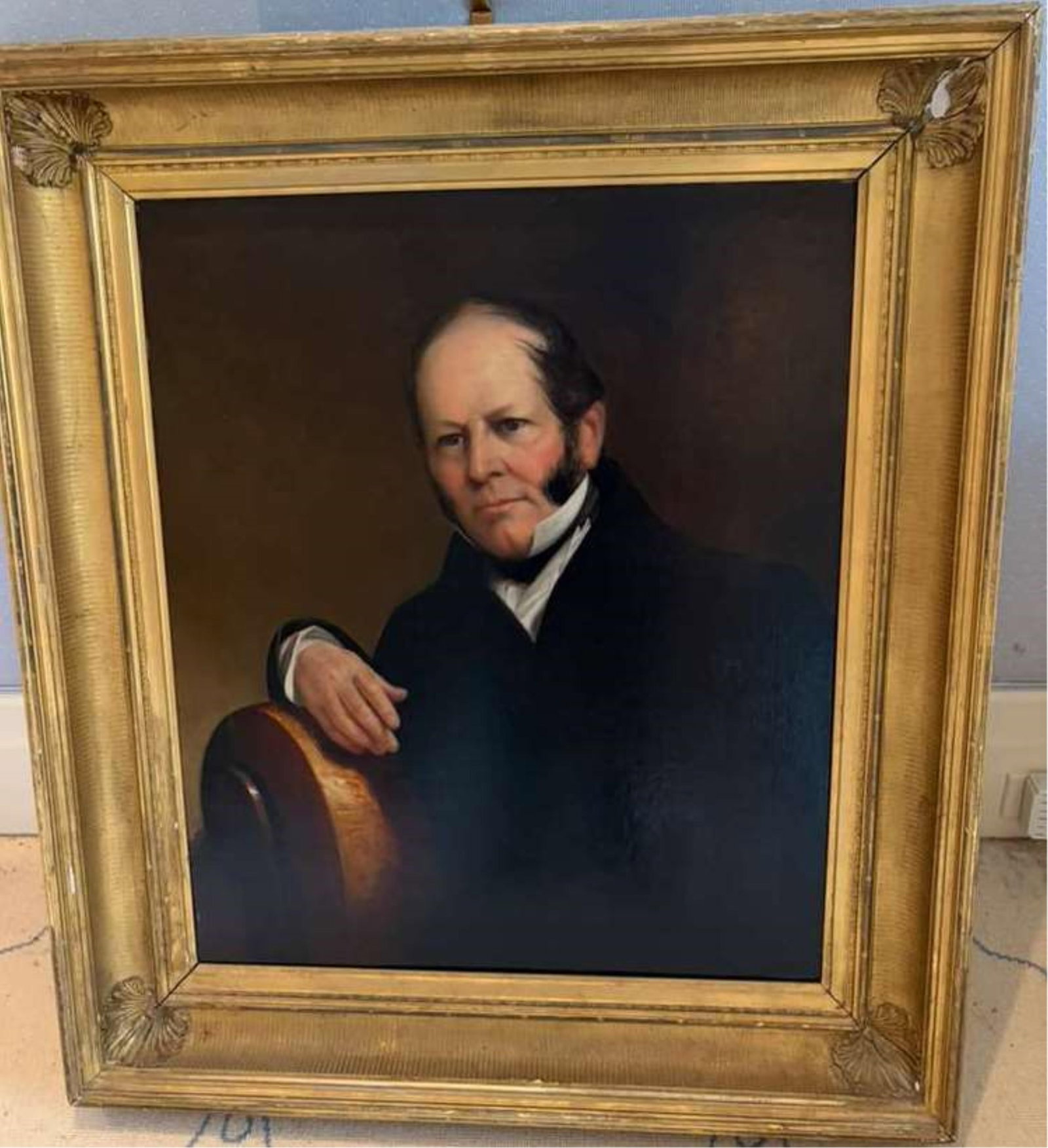 AMERICAN SCHOOL . Portrait of a Gentleman, Oil on canvas, 30 x 25 inches; frame: 39.5 x 34.5 inches: AMERICAN SCHOOL Portrait of a Gentleman Oil on canvas Half-length oil on canvas depicts a gentleman in a dark coat and white cravat, his arm resting on a mahogany chair back. The restrained palette, s