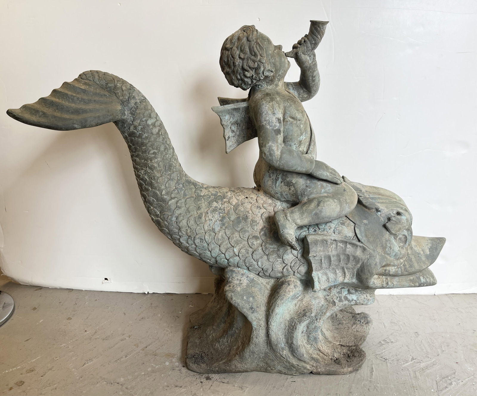 VINTAGE PATINATED METAL GARDEN STATUE CAST AS PUTTO RIDING ON DOLPHIN AND BLOWING HORN - H: 37 in. (1 of 4)
