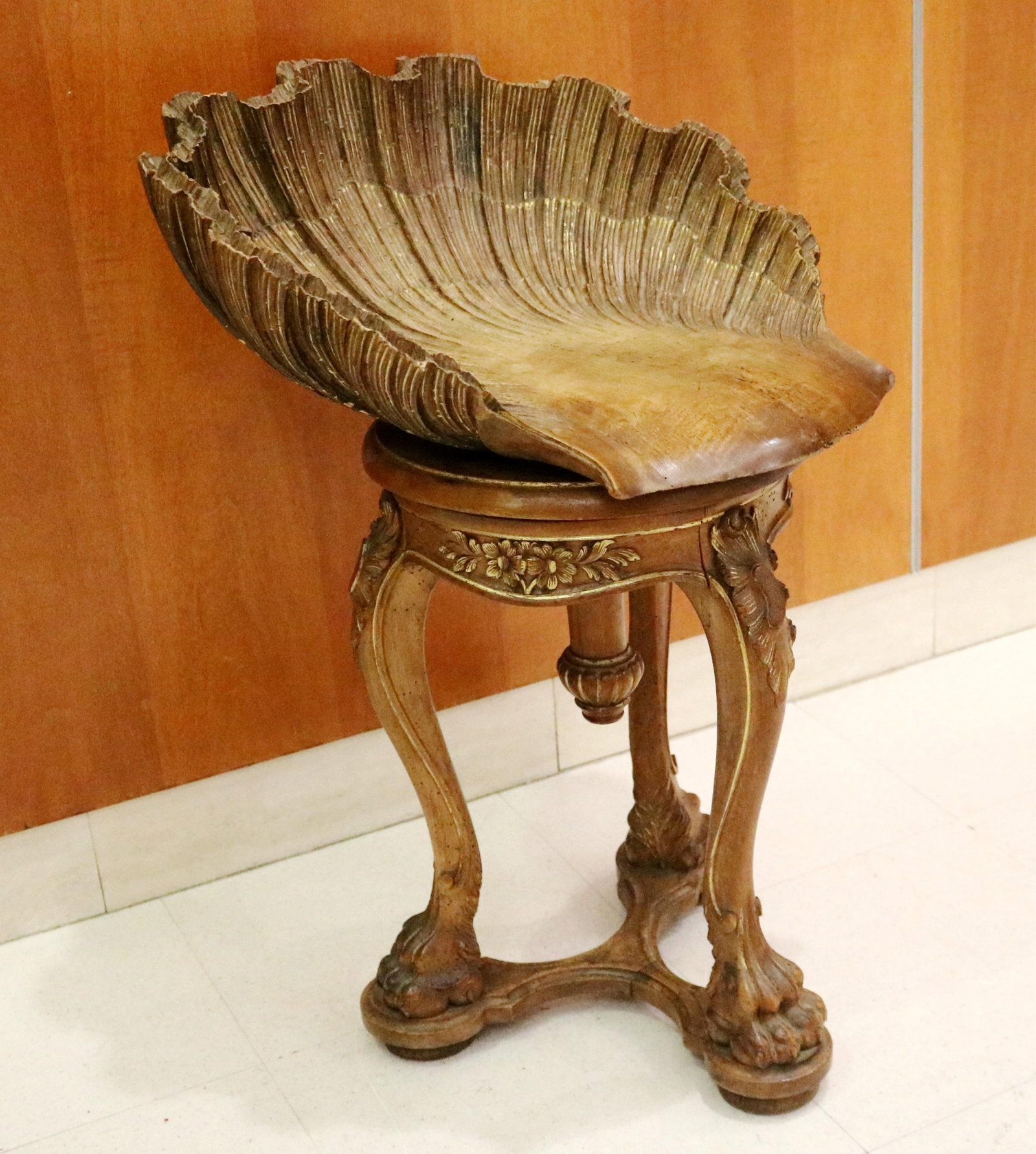ITALIAN SHELL-CARVED WOOD GROTTO CHAIR - H: 25 in.; W: 17 1/2 in.; D: 18 1/2 in..: ITALIAN SHELL-CARVED WOOD GROTTO CHAIR Adjustable. Three scrolling legs end in lion paw feet; gilt accents H: 25 in.; W: 17 1/2 in.; D: 18 1/2 in. PROVENANCE: ?Merry Hill?, an historic mansion built i