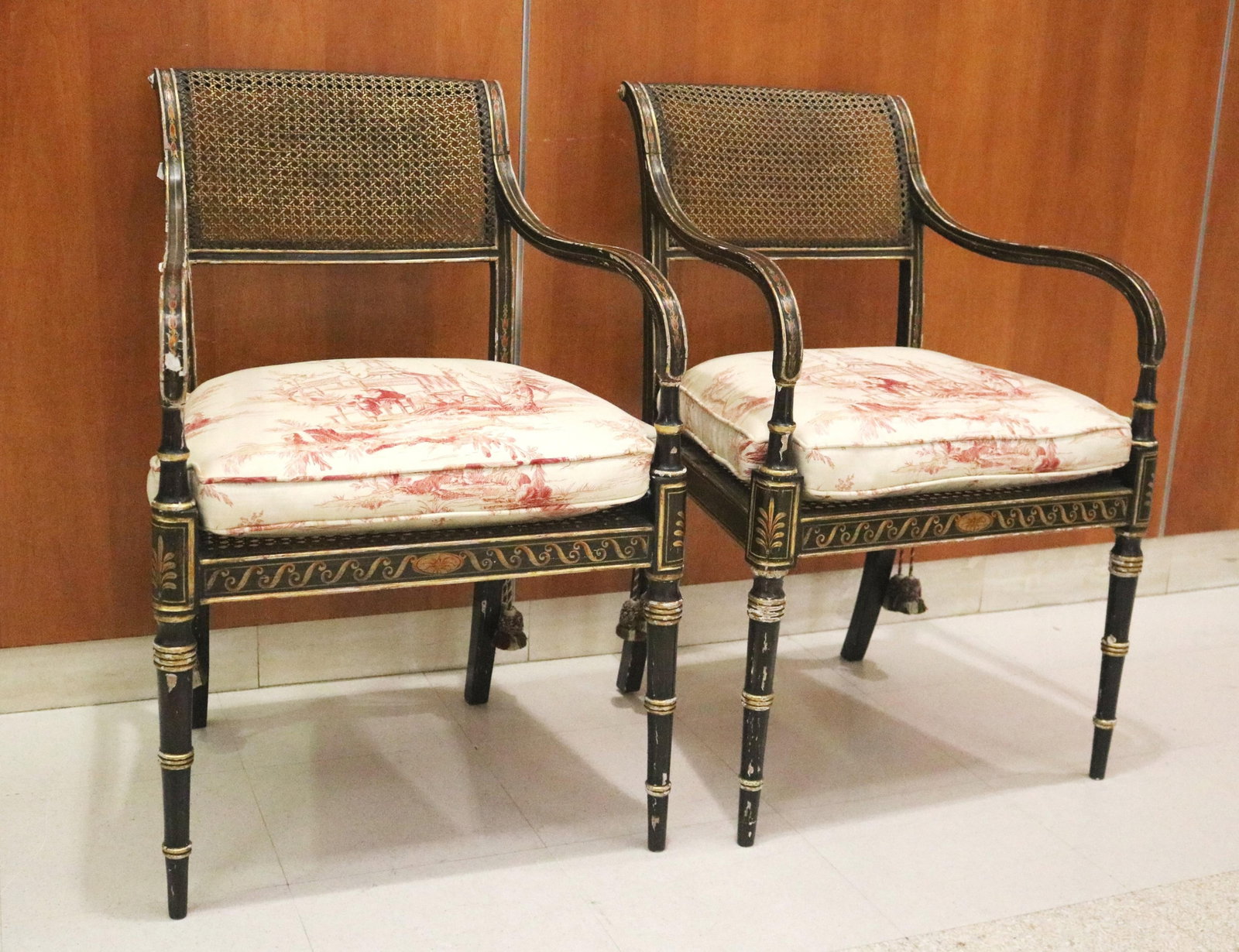 PAIR REGENCY STYLE BLACK AND GILT-FRAMED OPEN-ARM CHAIRS WITH CANED BACKS AND SEATS - H: 34 IN; W: (1 of 20)