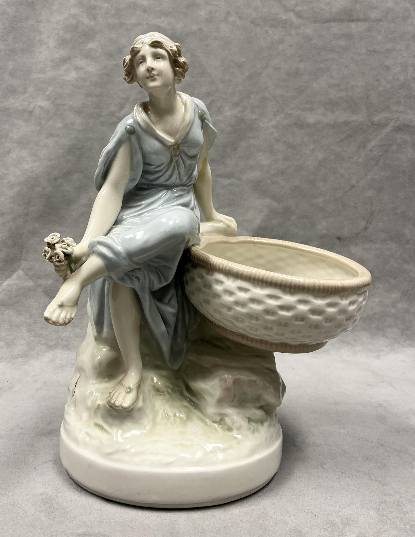 AMPHORA PORCELAIN CENTER PIECE MODELED AS SEATED NEOCLASSICAL MAIDEN WITH BASKET - H: 13 inches.. (1 of 9)
