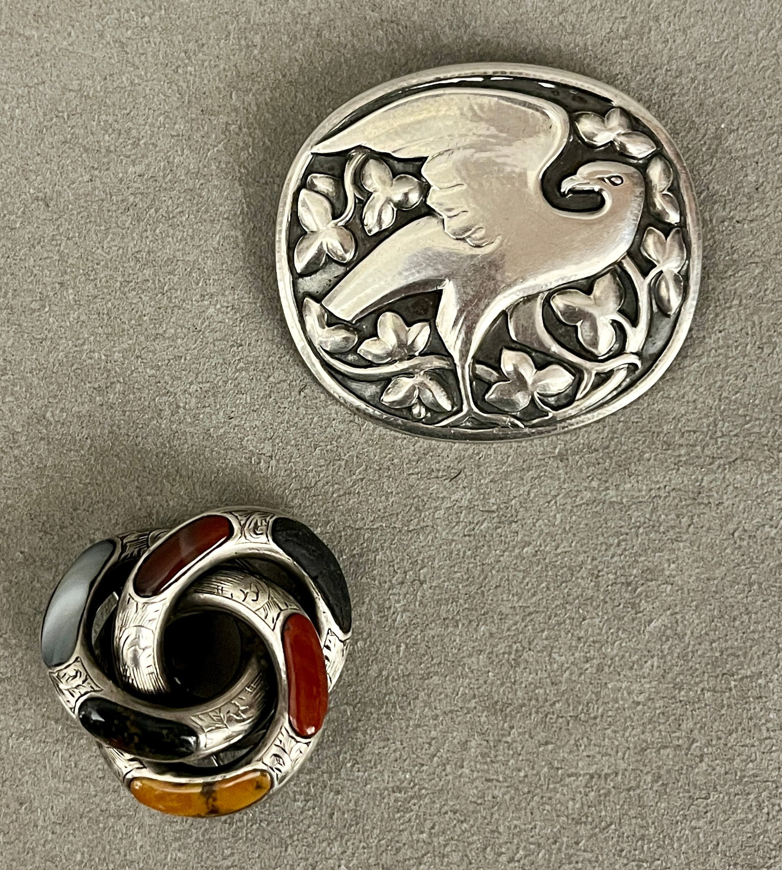 TWO VINTAGE STERLING SILVER PINS One, Georg Jensen oval pin with bird-in-branch motif, design (1 of 4)