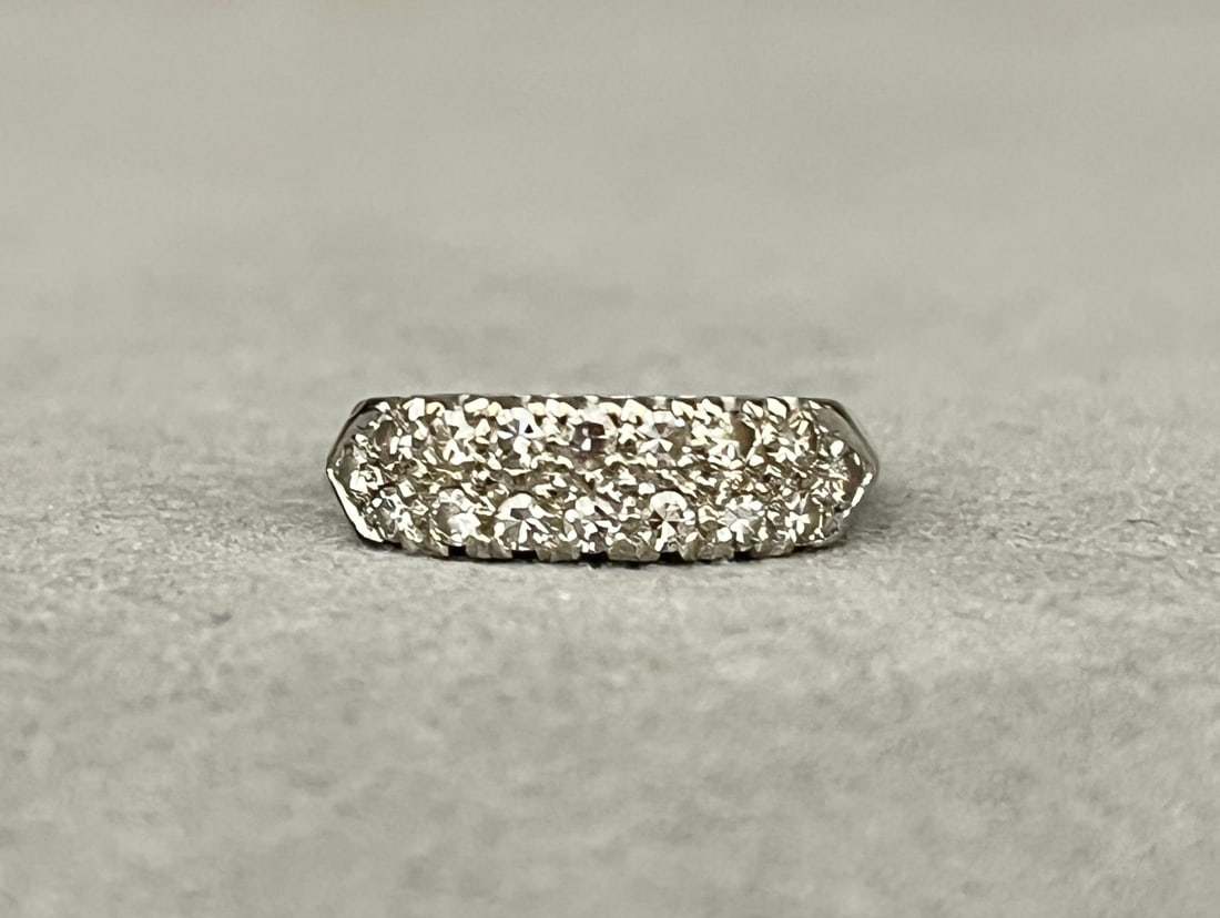 14K WHITE GOLD AND DIAMOND BAND Two rows of total of 16 matched round diamonds together weighing: 14K WHITE GOLD AND DIAMOND BAND Two rows of total of 16 matched round diamonds together weighing app. .50 ct. Ring size: 5 3/4. Gross wt. 2.5 dwt