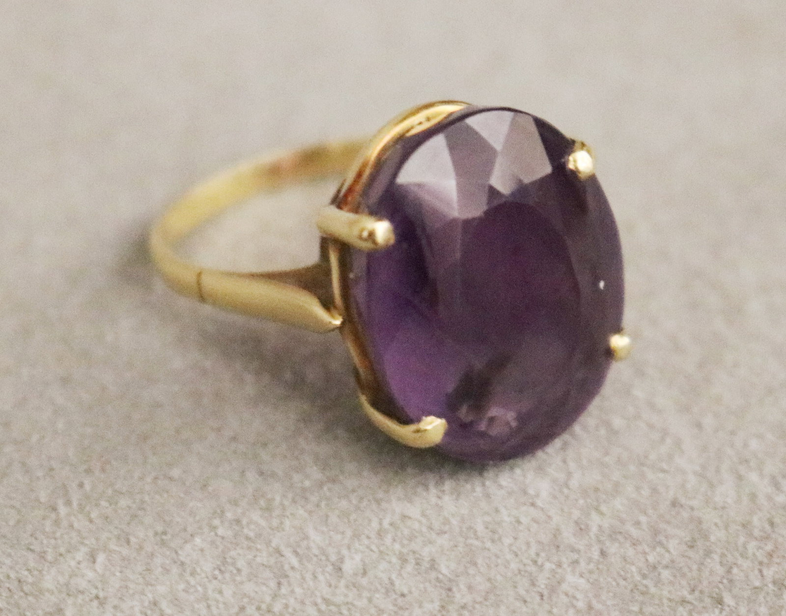 14K YELLOW GOLD AND AMETHYST RING Oval amethyst weighing app. 8-10 ct. held by four prongs Ring: 14K YELLOW GOLD AND AMETHYST RING Oval amethyst weighing app. 8-10 ct. held by four prongs Ring size: 6 1/4. Gross wt. 5 dwt