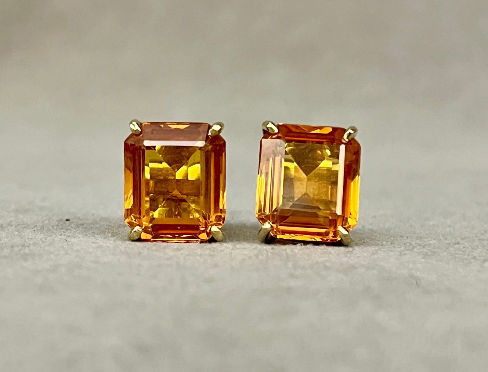 PAIR 14K YELLOW GOLD AND CITRINE STUD EARRINGS Each earring has emerald-cut citrine of: PAIR 14K YELLOW GOLD AND CITRINE STUD EARRINGS Each earring has emerald-cut citrine of apricot-amber color weighing 3-4.00 ct. in four-prong setting. Threaded post backs.