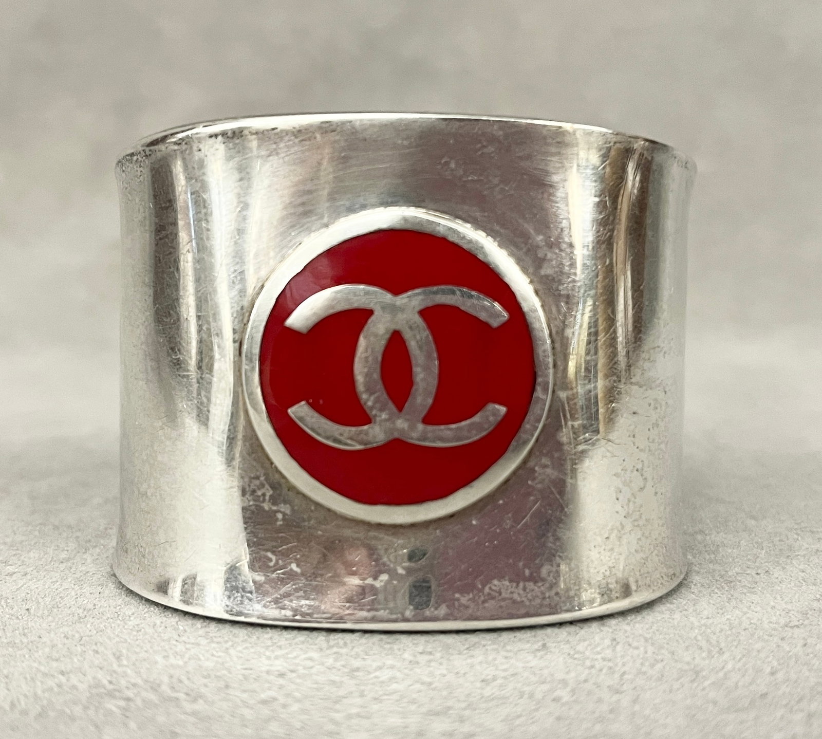 CHANEL STERLING SILVER AND RED ENAMEL LOGO CUFF BRACELET Open-ended oval sterling cuff centers (1 of 5)