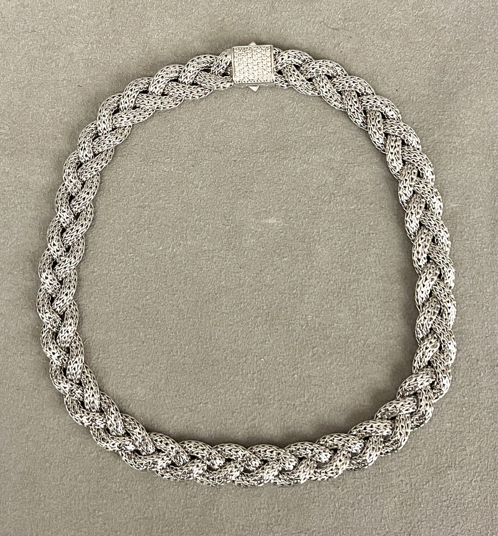 SIGNED JOHN HARDY STERLING SILVER BRAIDED FLEXIBLE STRAP CHOKER WITH DIAMOND CLASP Square clasp: SIGNED JOHN HARDY STERLING SILVER BRAIDED FLEXIBLE STRAP CHOKER WITH DIAMOND CLASP Square clasp pave-set with matched round diamonds. L: 18". W: 5/18". Gross wt: 4 oz. 14 dwt.